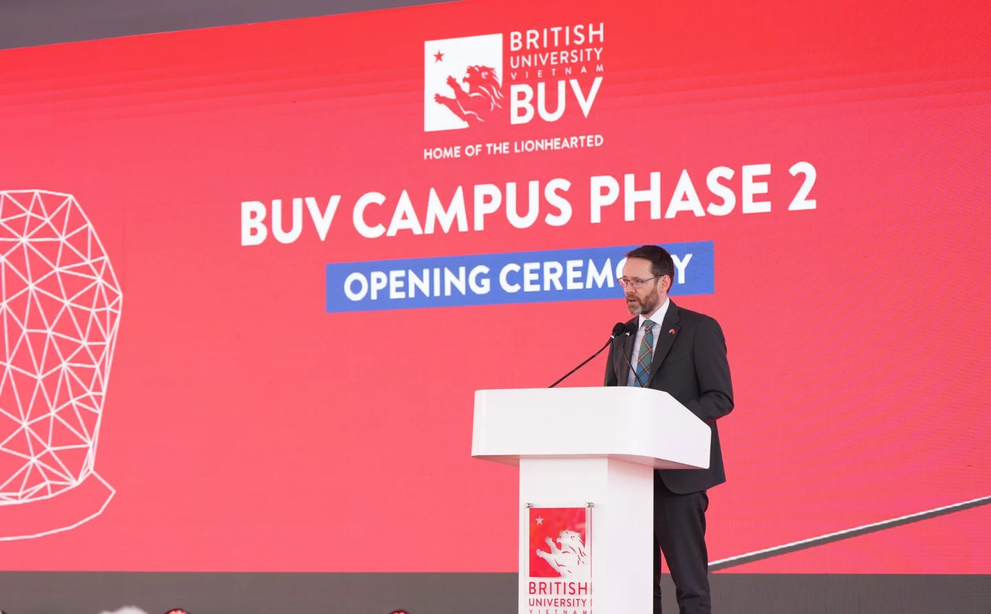 A speaker delivers remarks at the podium during the opening ceremony for Phase 2 of the British University Vietnam campus.