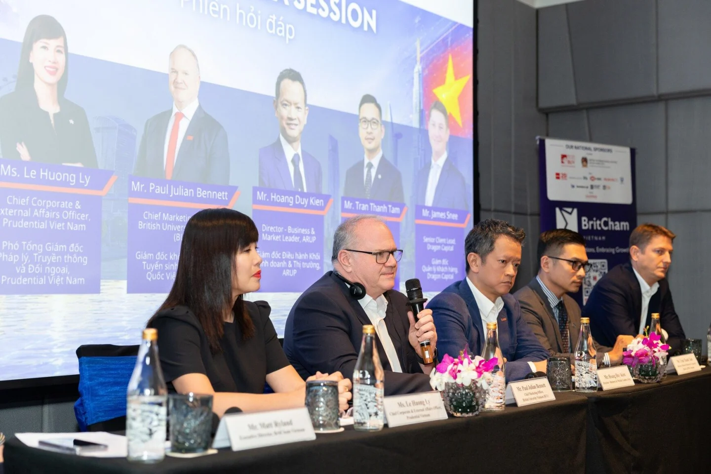 BUV business panel discussion in Vietnam featuring British and Vietnamese industry leaders on stage.