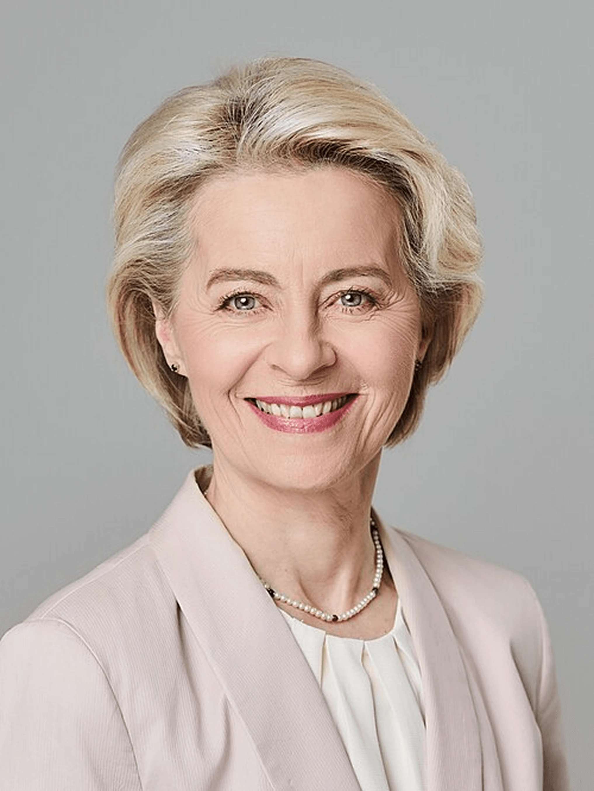 Ursula von der Leyen, President of the European Commission, smiling in a formal portrait.