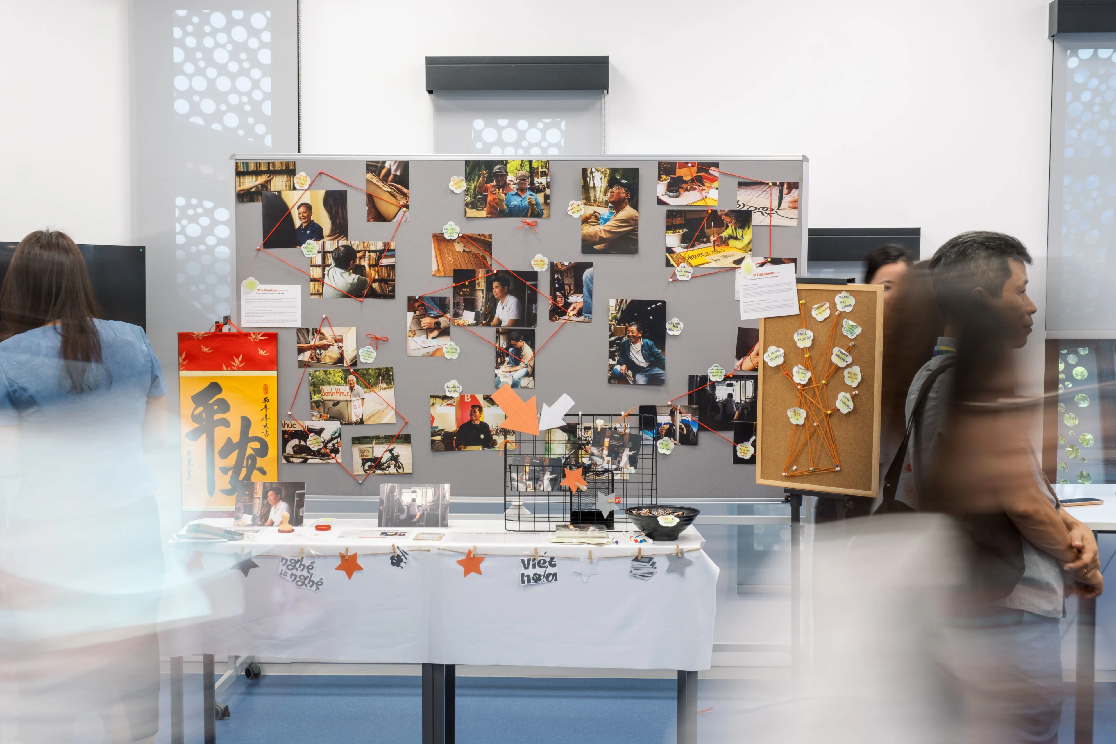 Visitors explore a student photography and research exhibition at British University Vietnam.