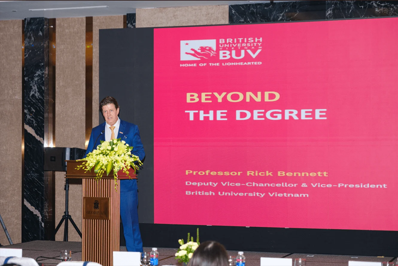 Professor Rick Bennett speaks at a British University Vietnam event, with “Beyond the Degree” displayed on stage.