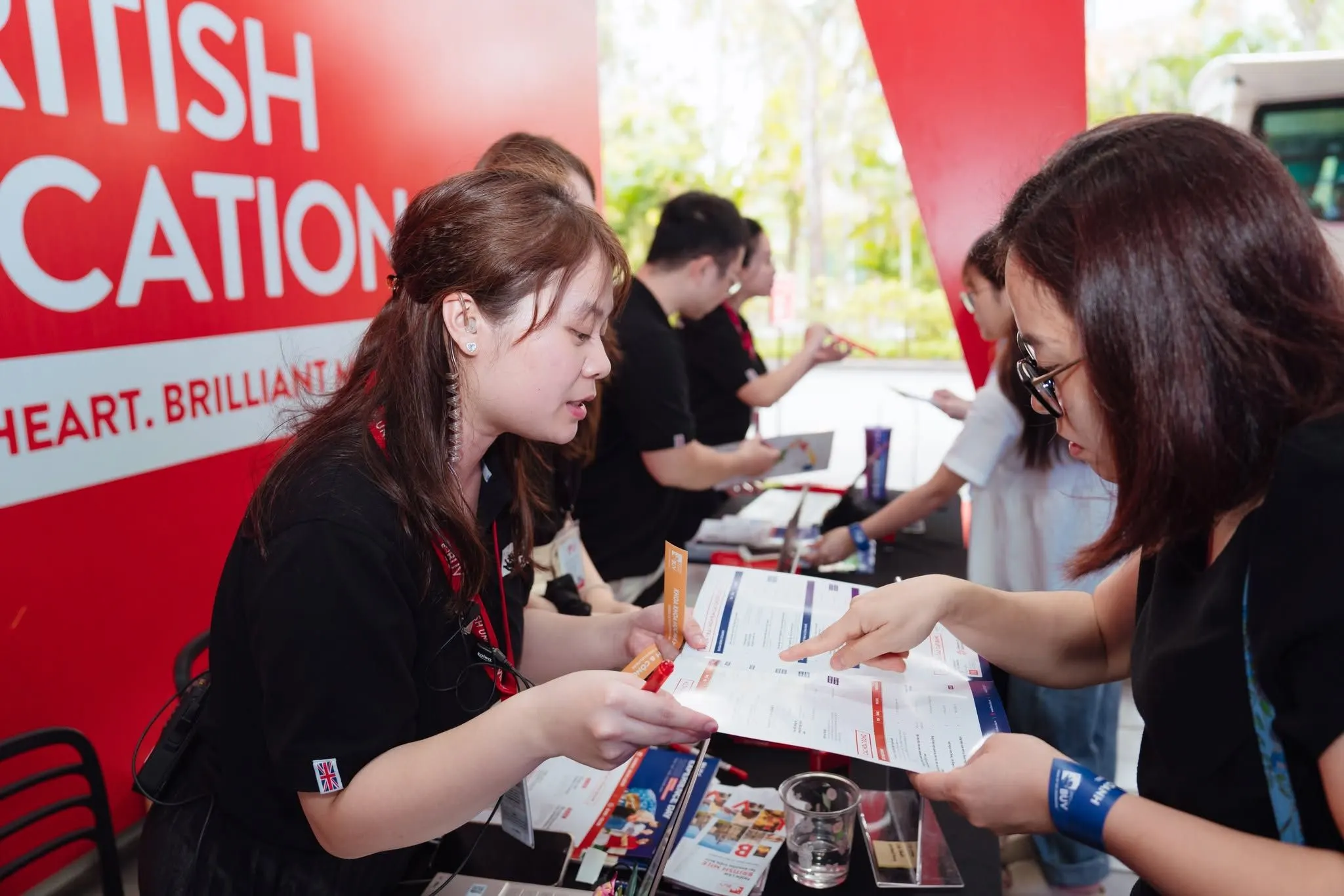 BUV admissions adviser discusses application documents with a prospective student at an admissions event.