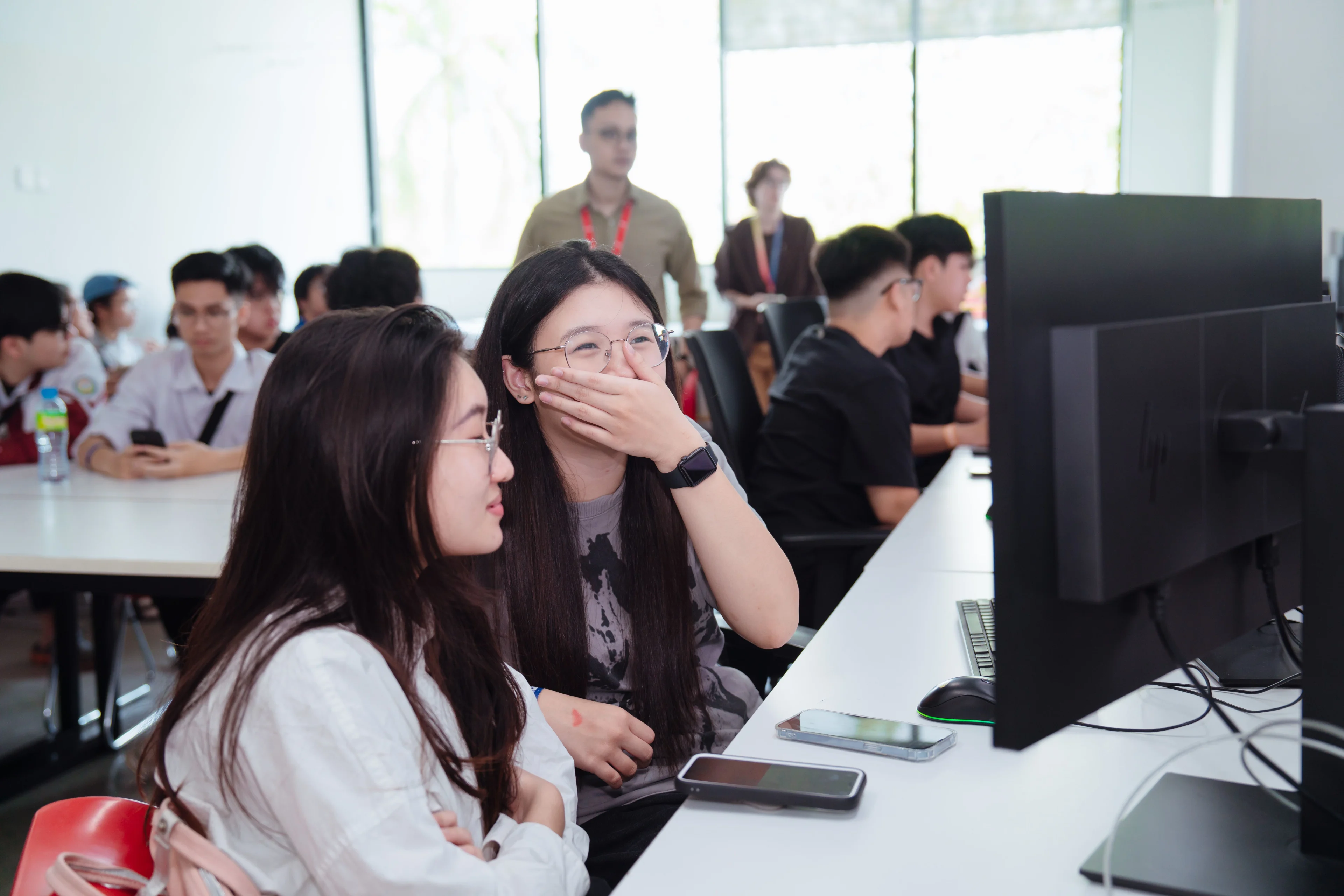 BUV students collaborate in a modern computer lab during an international university learning session.