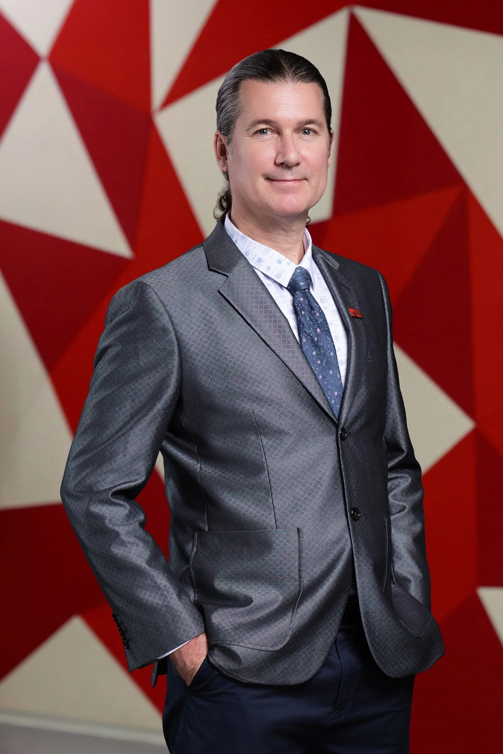 James McGaughran in a grey suit at British University Vietnam (BUV)