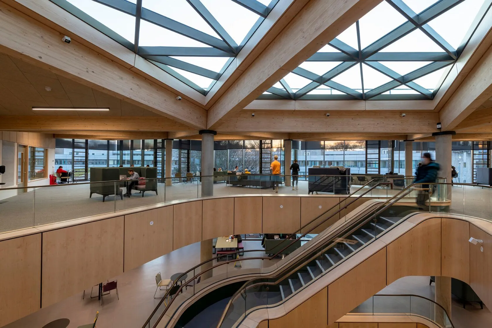 Modern BUV university campus atrium with students, escalators, wooden interiors and a glass skylight