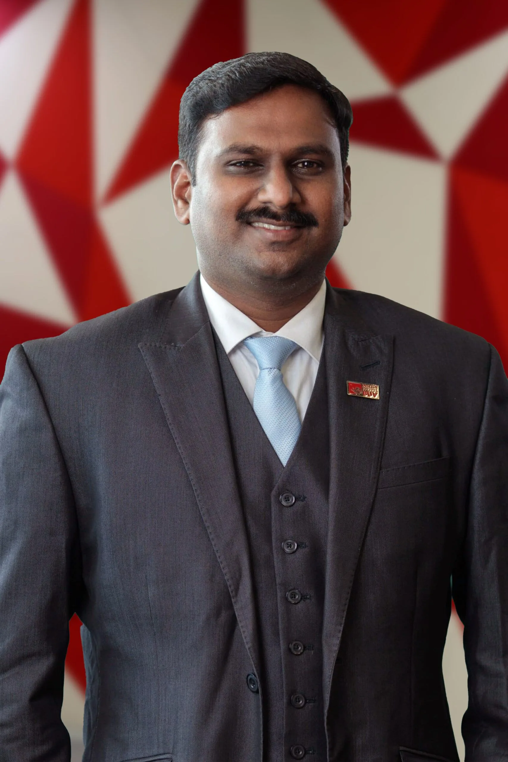 Dr Viju Prakash in a dark suit and blue tie at British University Vietnam (BUV)