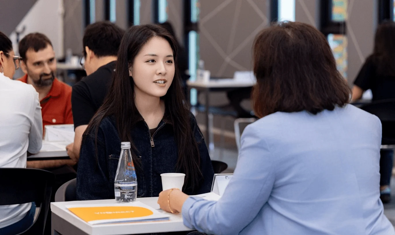 BUV student discussing university admissions with an advisor at an international education event