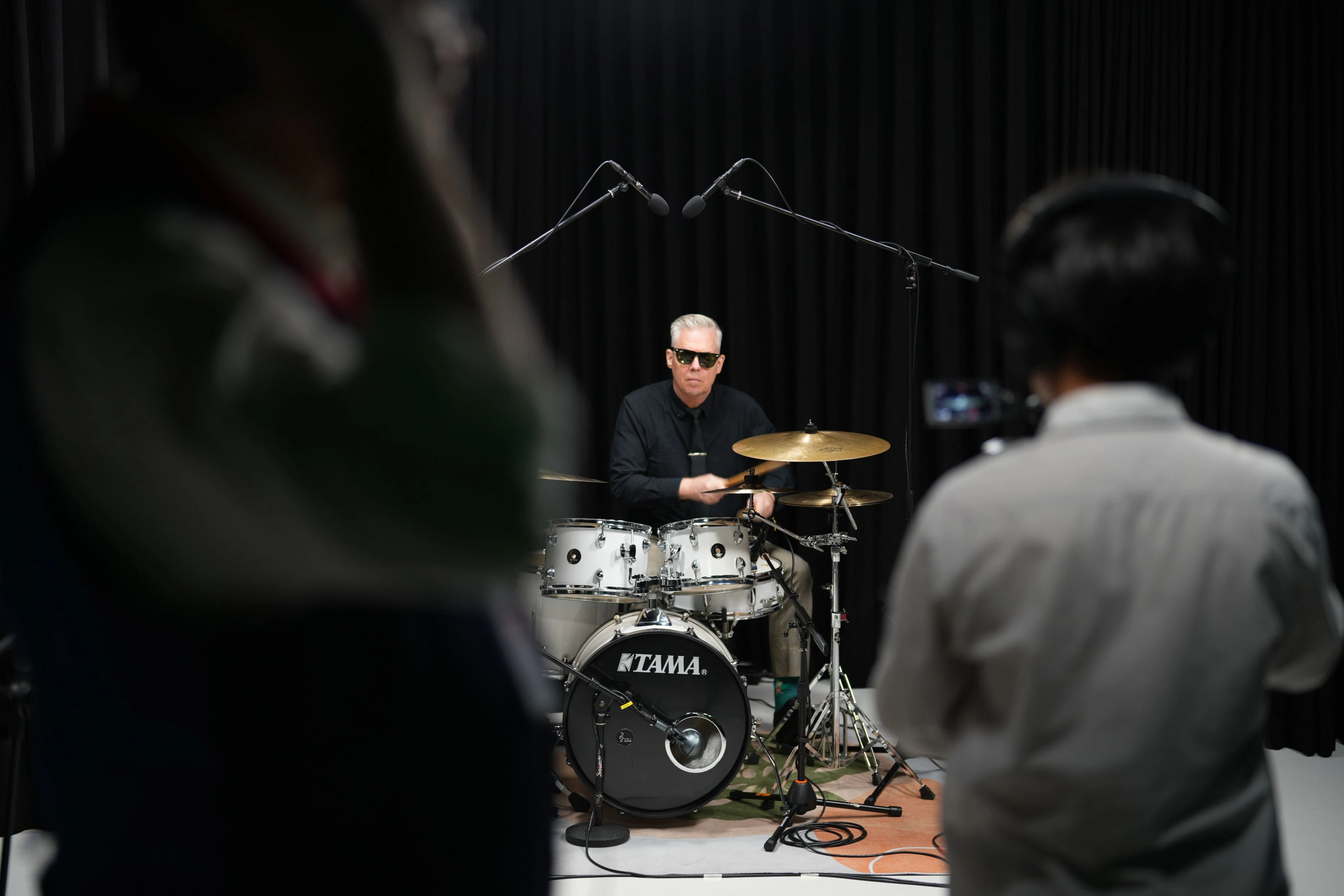 Drummer performs on a TAMA drum kit during a music production session at British University Vietnam.