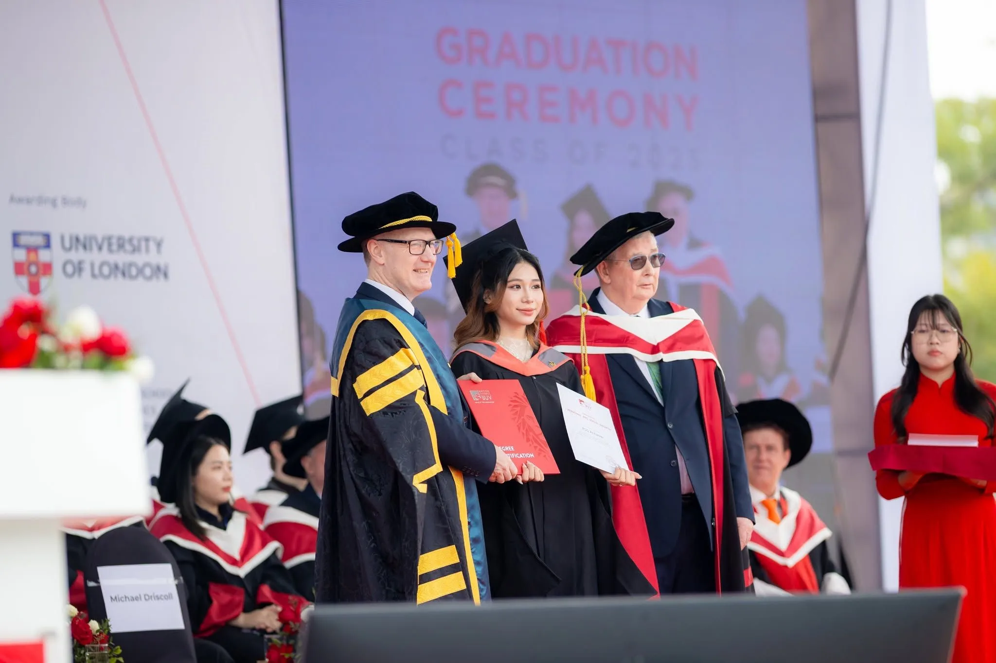 A graduate receiving a certificate at a graduation ceremony.