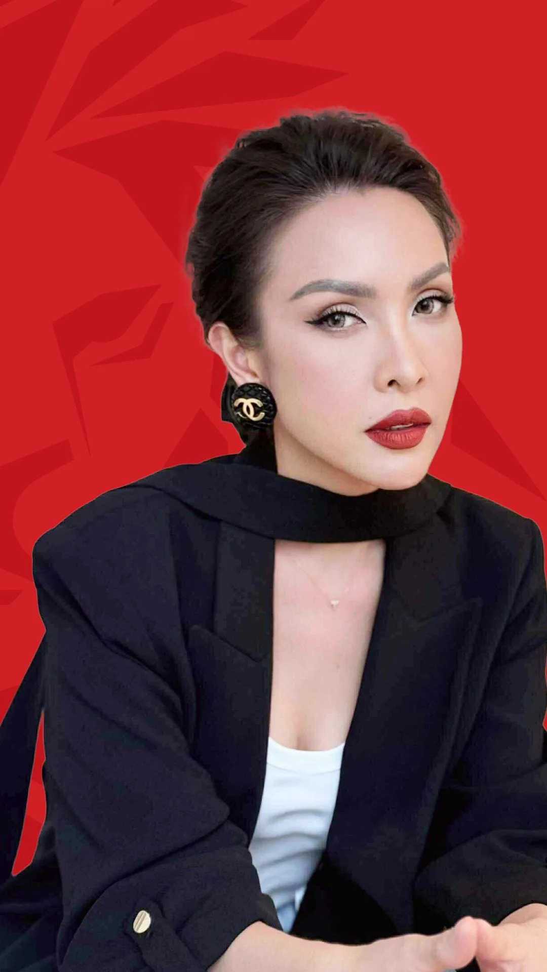 BUV alumna Xuân Tiên in a black blazer against a red background, featured in the Lionhearted alumni campaign.