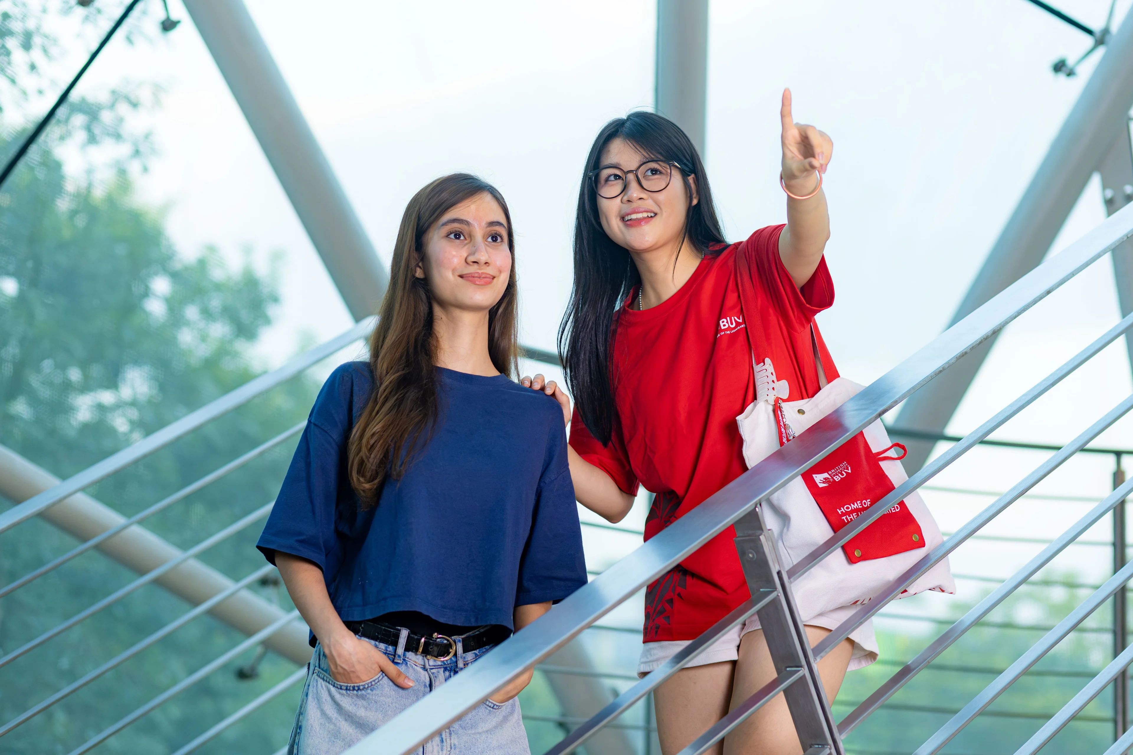 BUV student ambassador guides an international student around British University Vietnam’s modern campus.