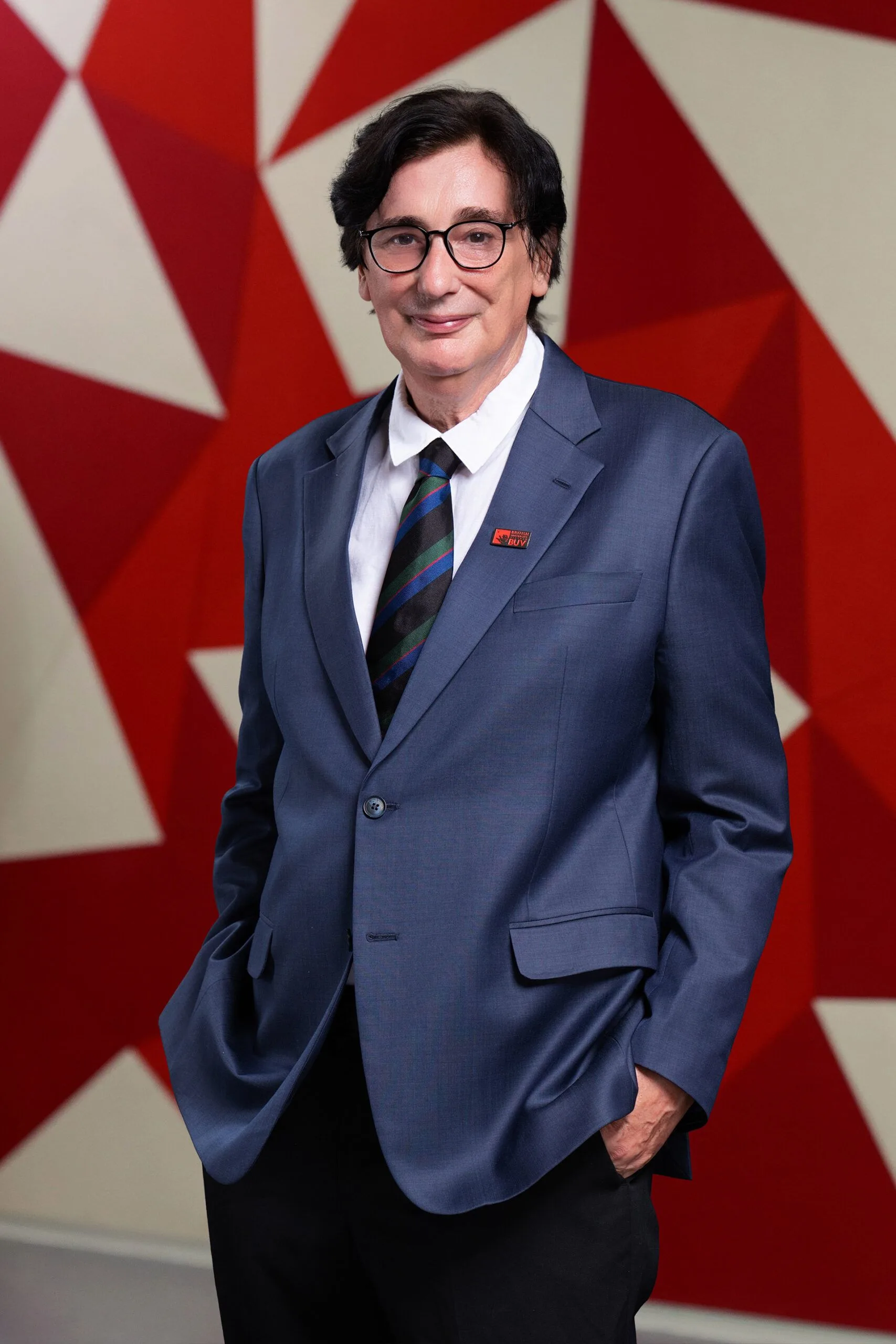 Dr Chris Kirrane wearing a blue suit and BUV pin at British University Vietnam