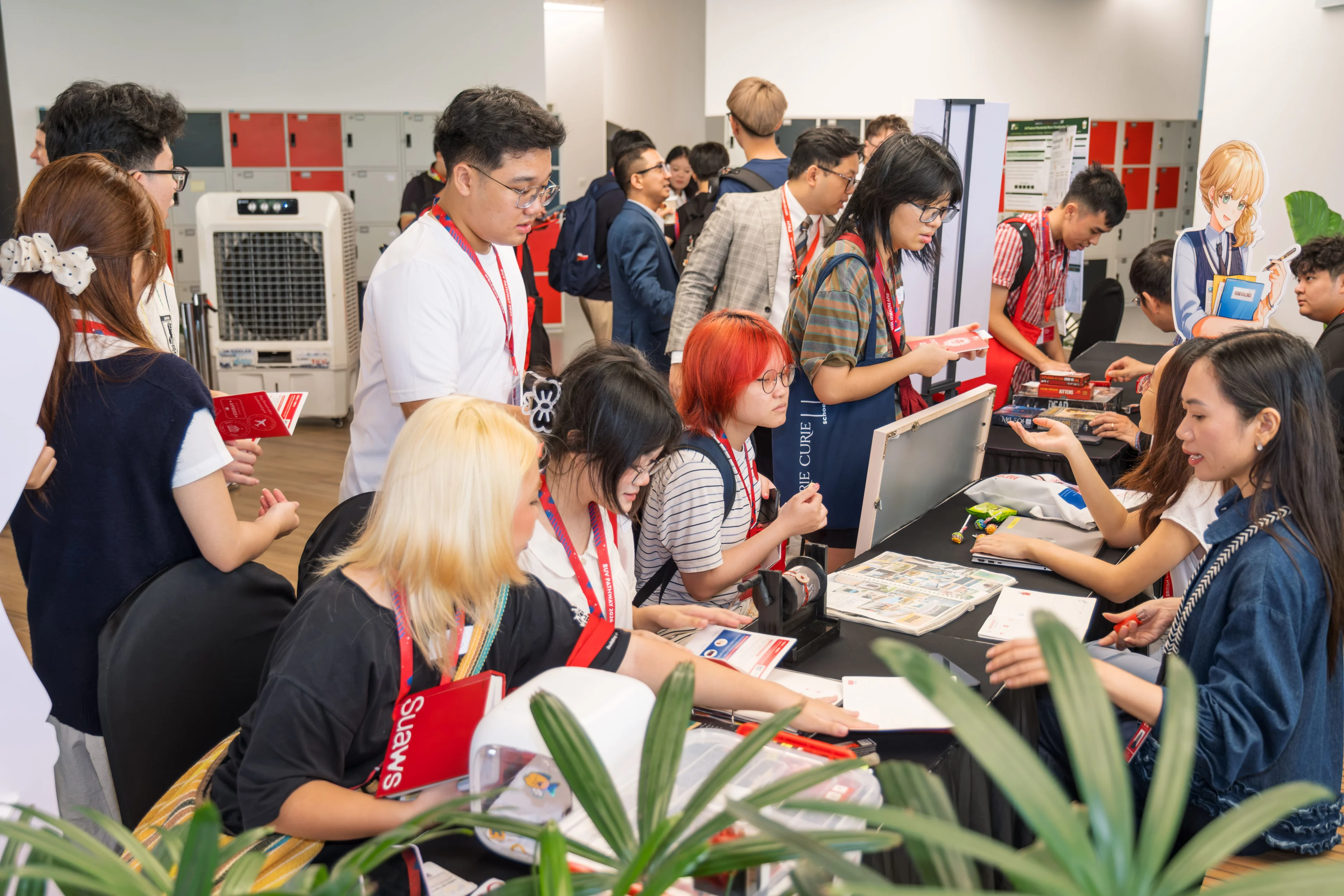 BUV students exploring university pathway booths at a busy campus event