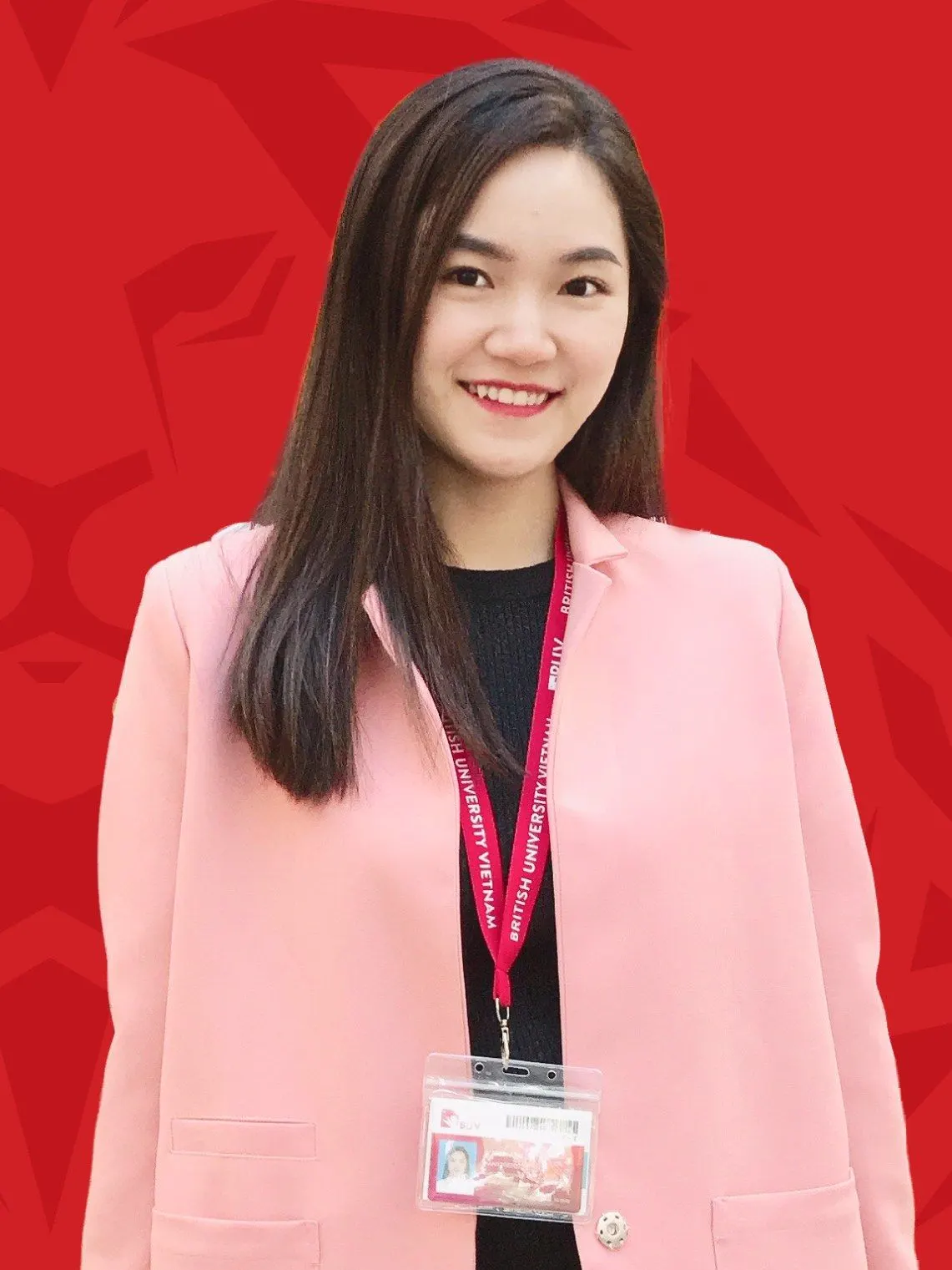 Minh Anh, British University Vietnam staff member, smiling in a pink blazer against a red background.