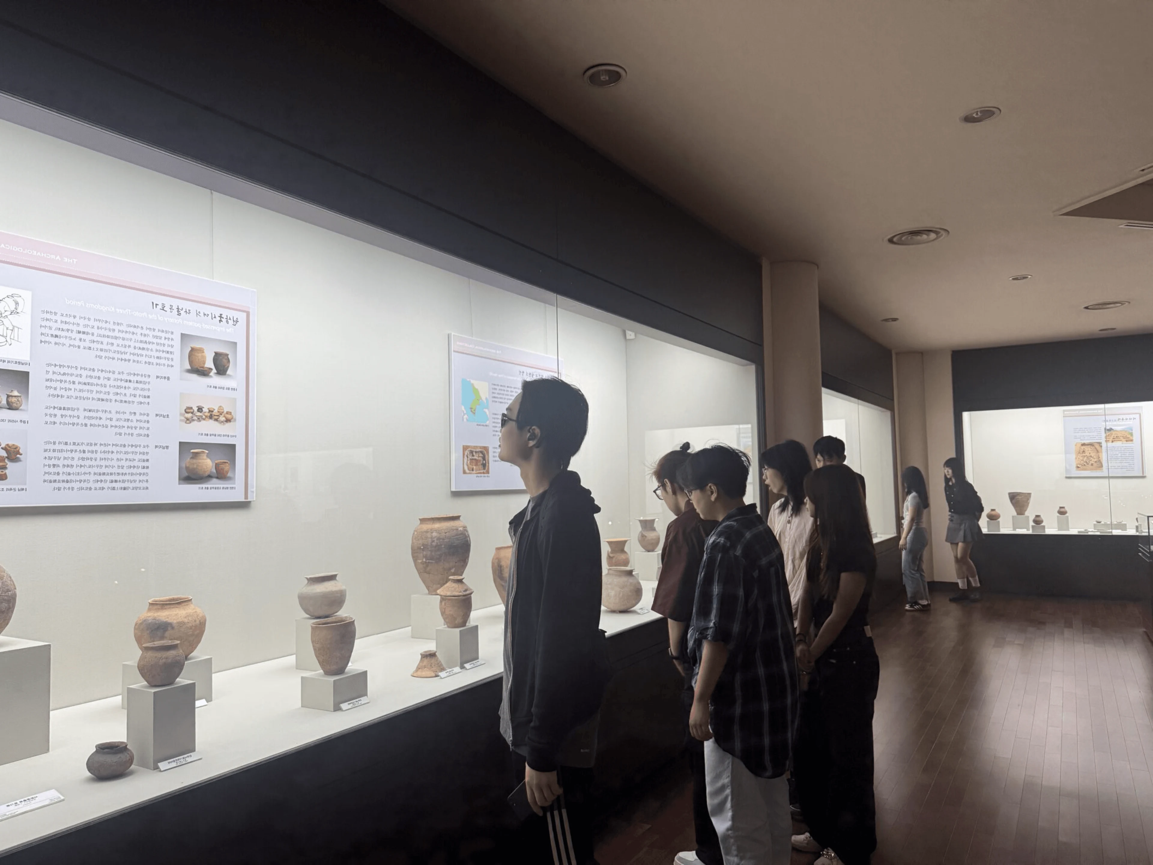 BUV international study course students exploring ancient pottery in a museum exhibition
