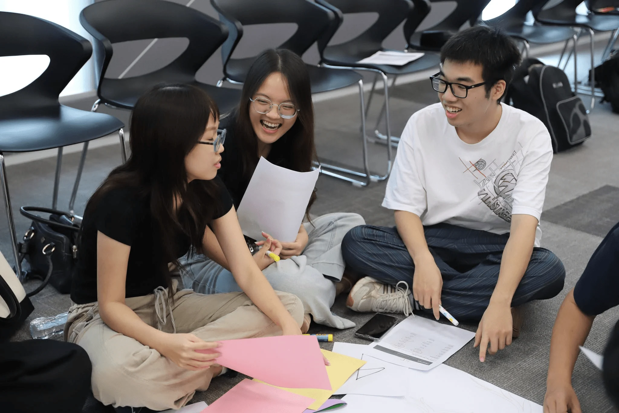 BUV students collaborating on a wellbeing activity with papers and markers in a classroom