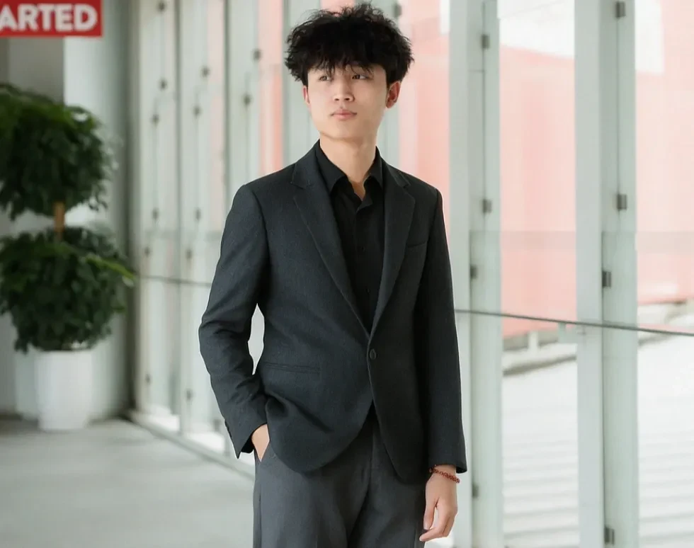 Nguyen Phuc The, BUV student and Education Development Scholarship recipient, wearing a black suit