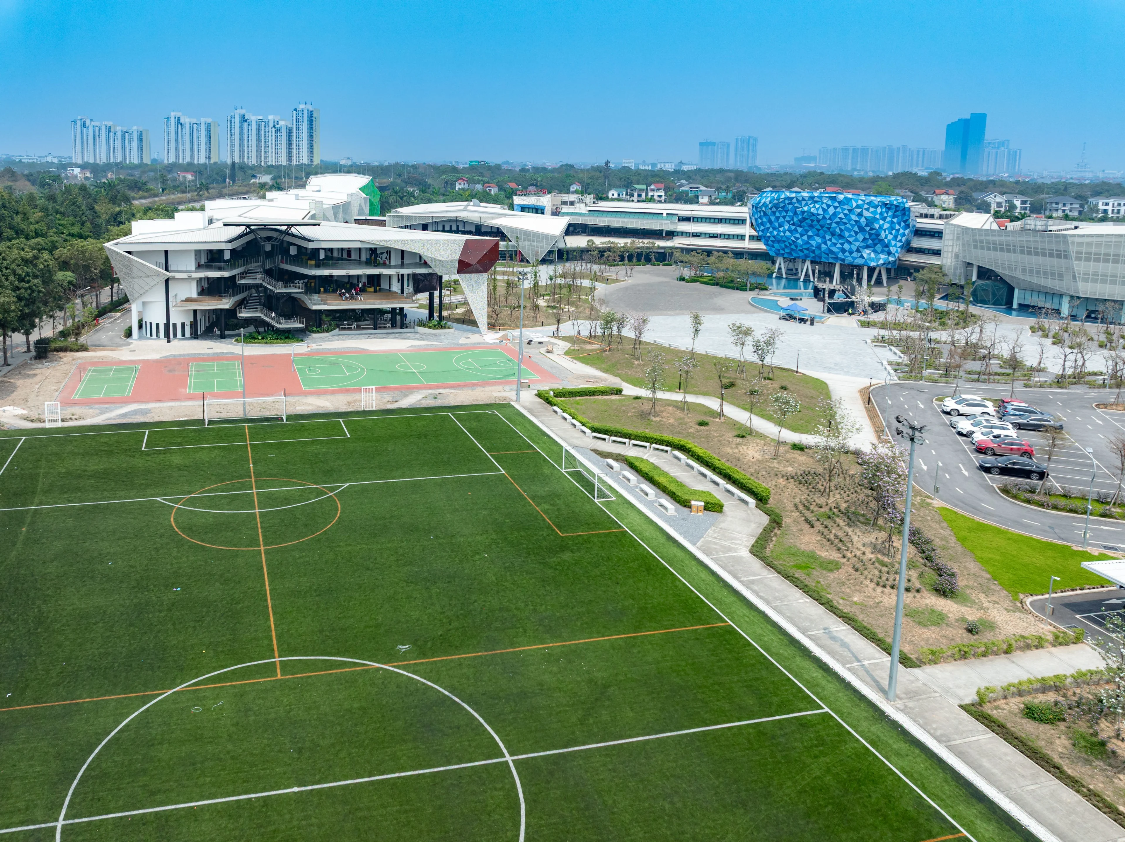 Aerial view of BUV campus in Vietnam with football field, sports courts and modern university buildings