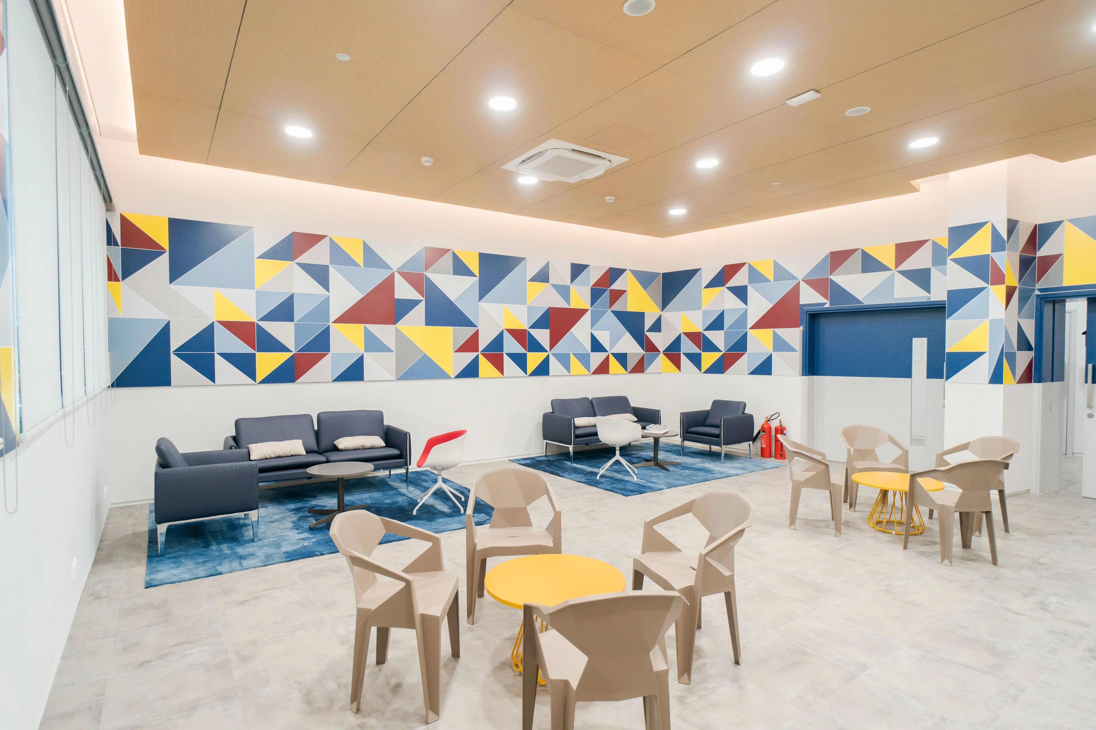 BUV student lounge with colorful geometric mural, sofas and study seating in a modern university campus