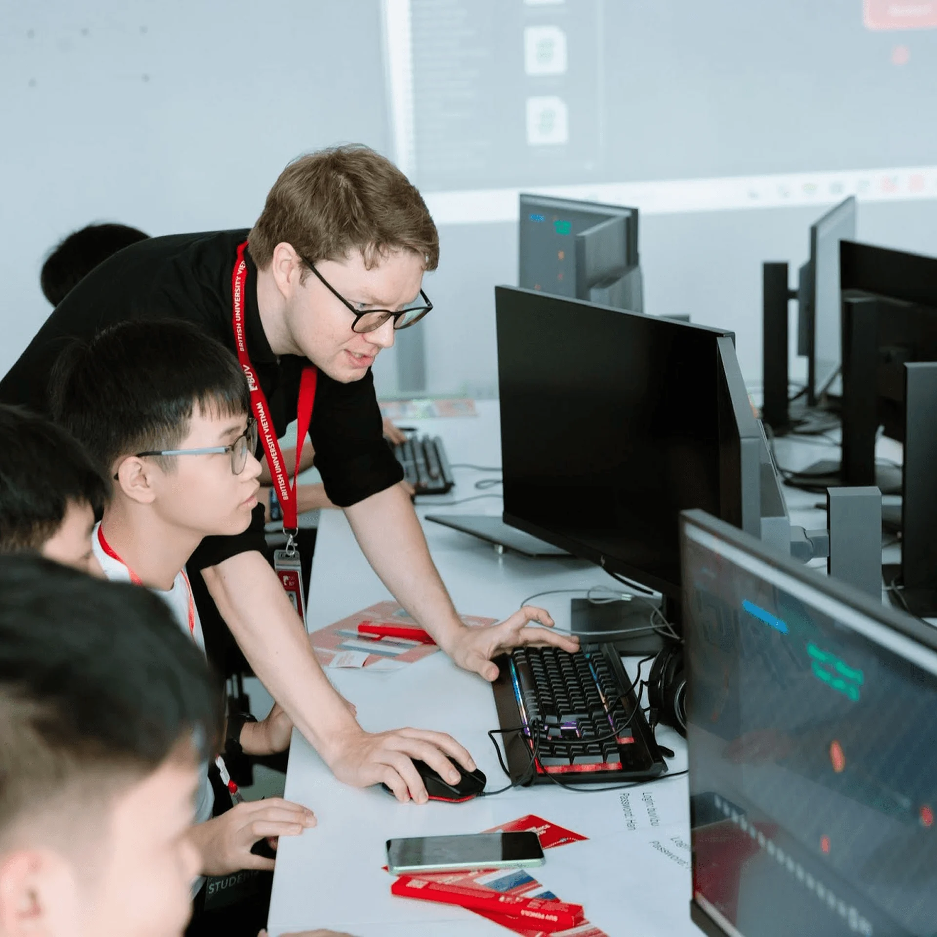 BUV students learn in a computer lab with an instructor during a practical technology class.