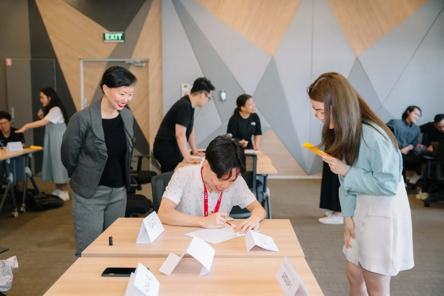 BUV students collaborate at a university workshop with event materials and discussion tables.