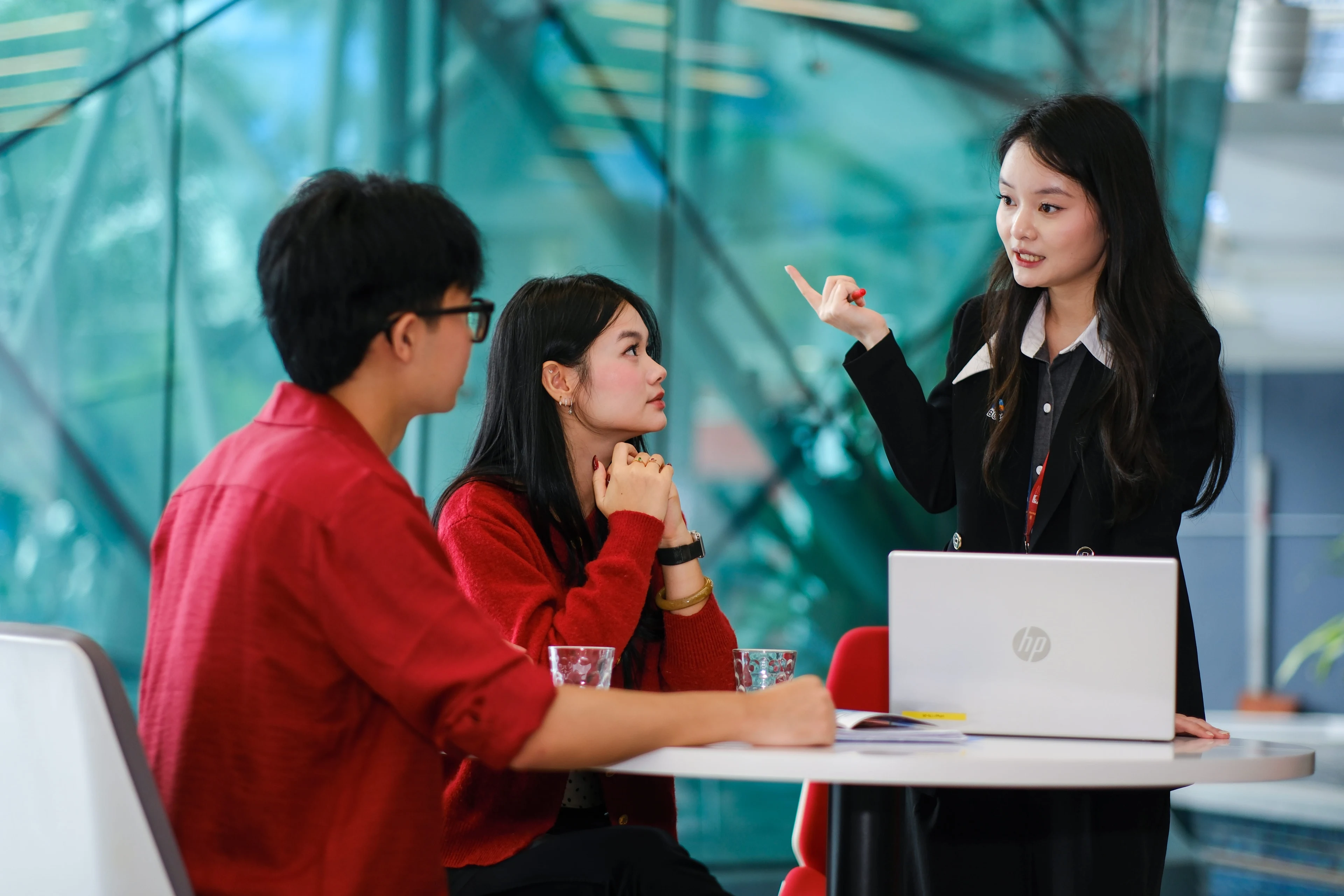 BUV university advisor discussing UK study options with two students at an admissions consultation table