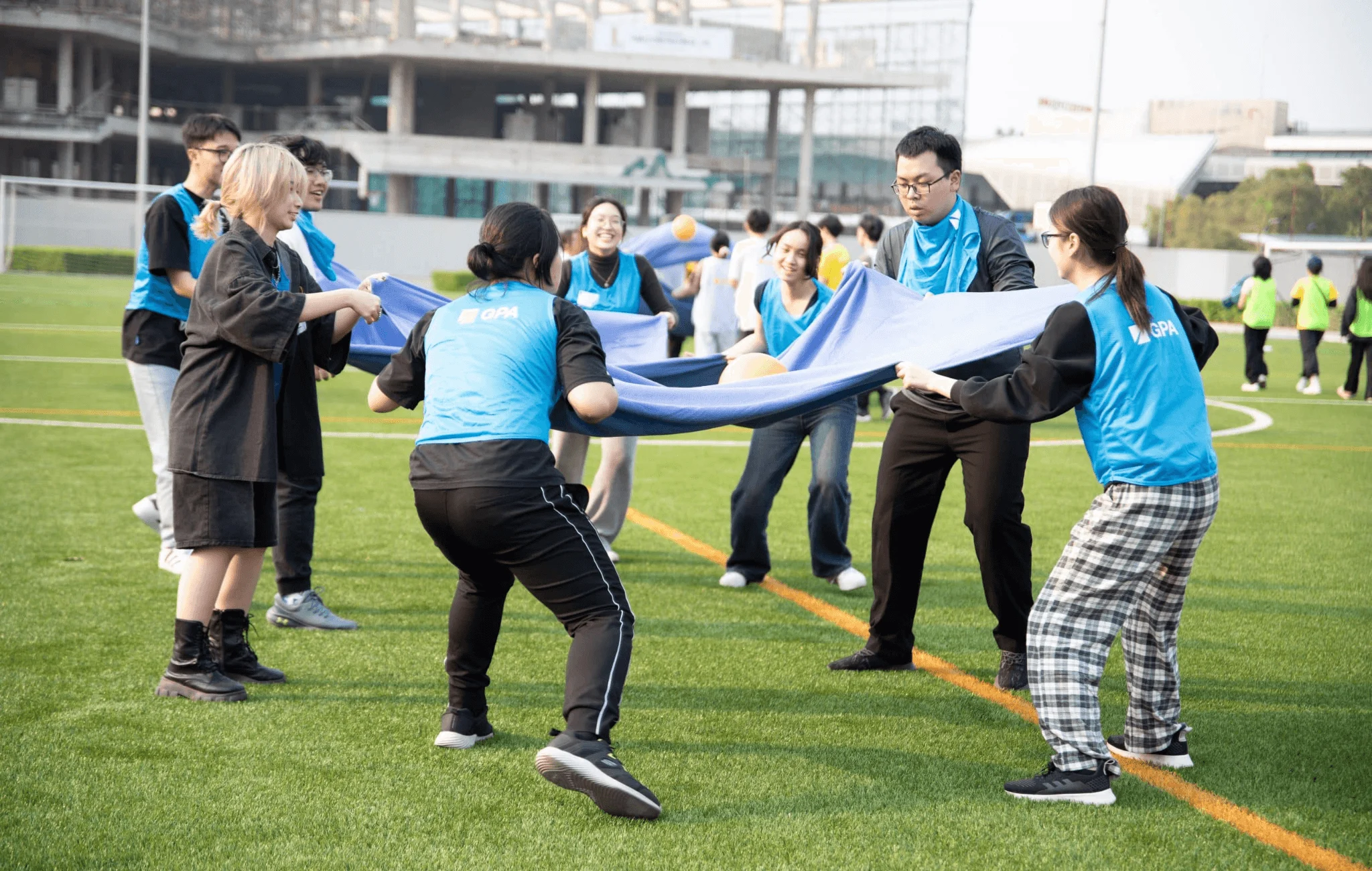 BUV students take part in an outdoor team-building activity on a football field