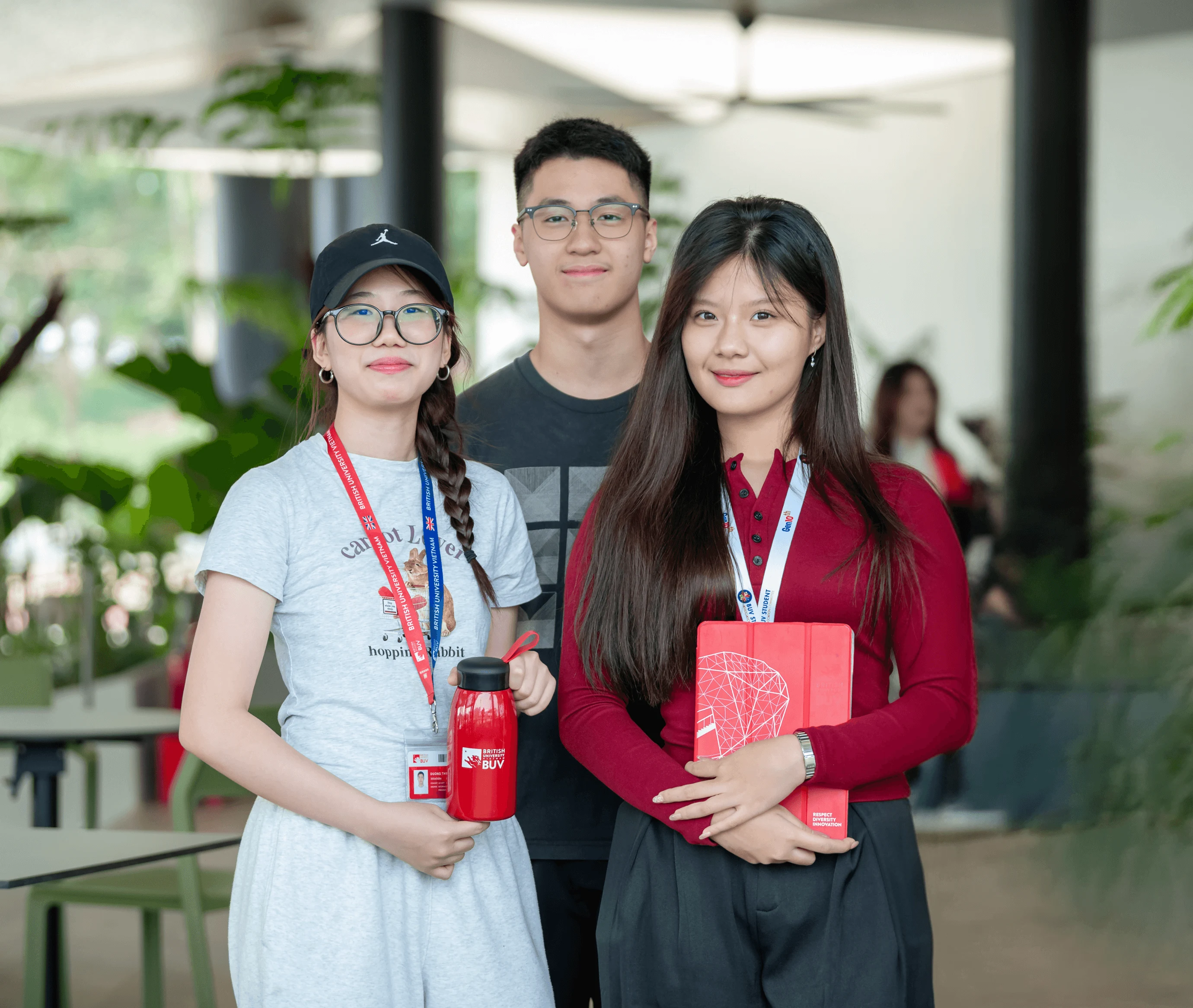 BUV student committee members posing together on campus with university IDs and branded merchandise