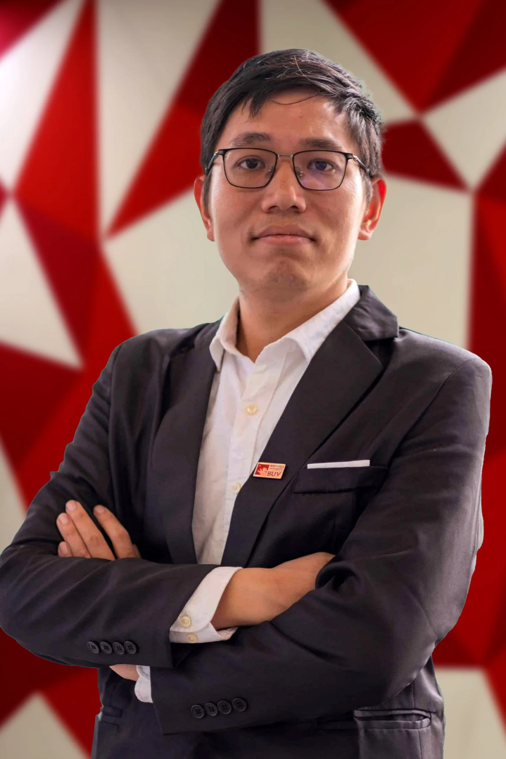 Dr Dang Quang Vinh, British University Vietnam academic, wearing a dark suit and BUV pin