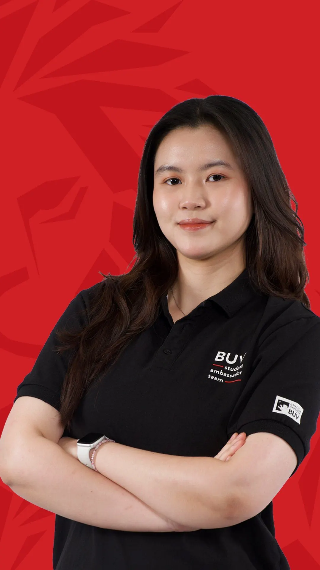 BUV alumna Minh Khuê in a black student ambassador polo against a red background.