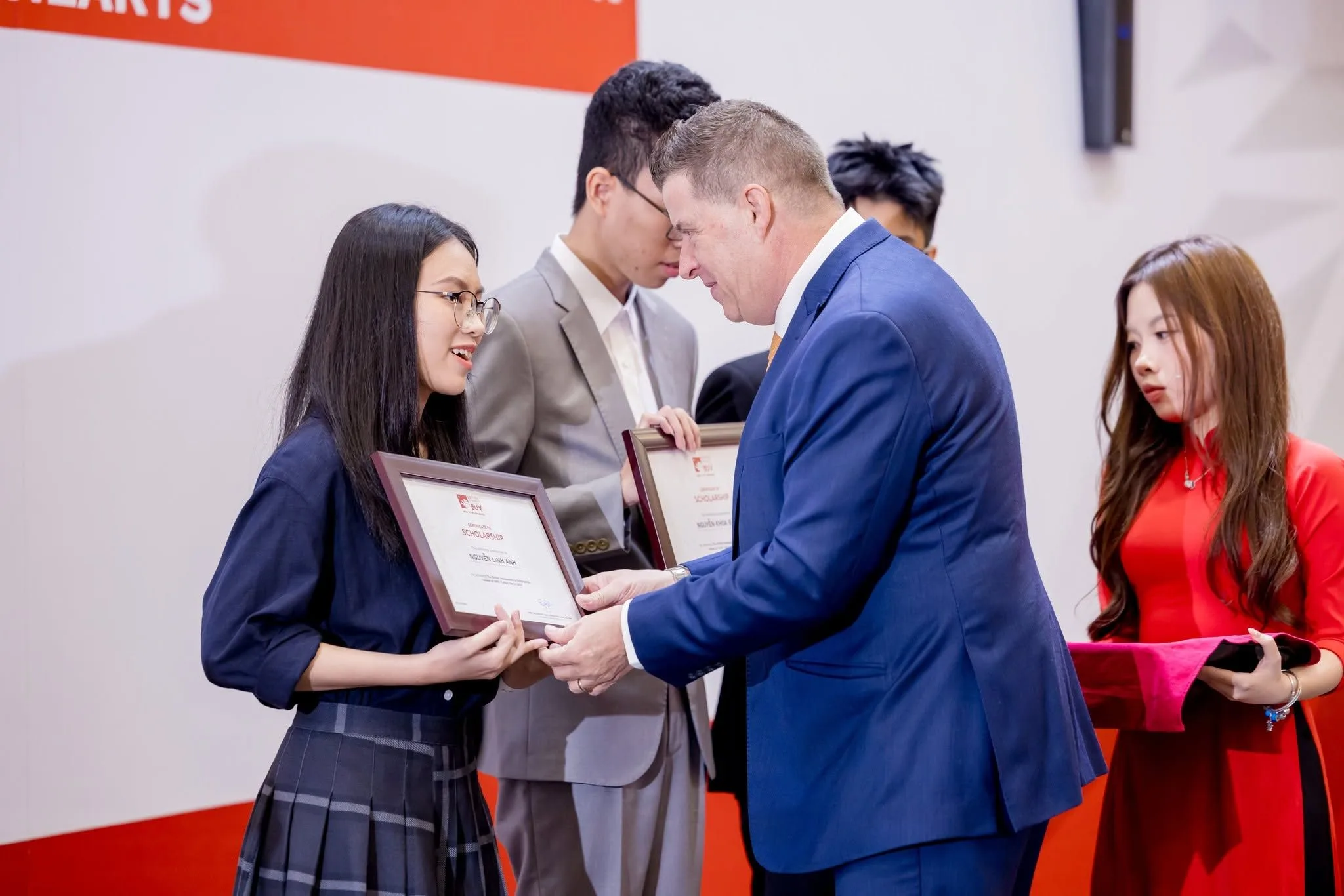 BUV student receives the British Ambassador Scholarship certificate at an award ceremony in Vietnam