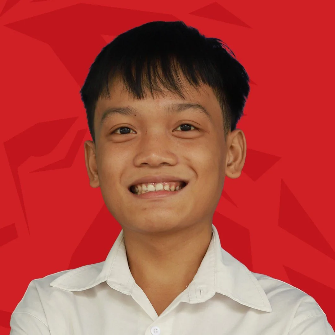 BUV alumnus Thanh Nhat smiling in a white shirt against a red background.