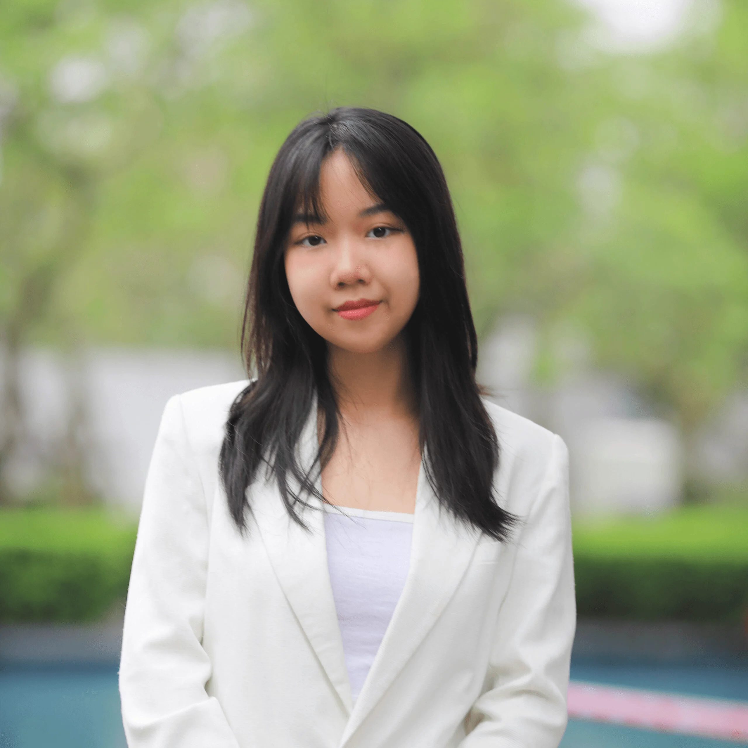 Ha Vy, BUV student portrait wearing a white blazer outdoors on campus.
