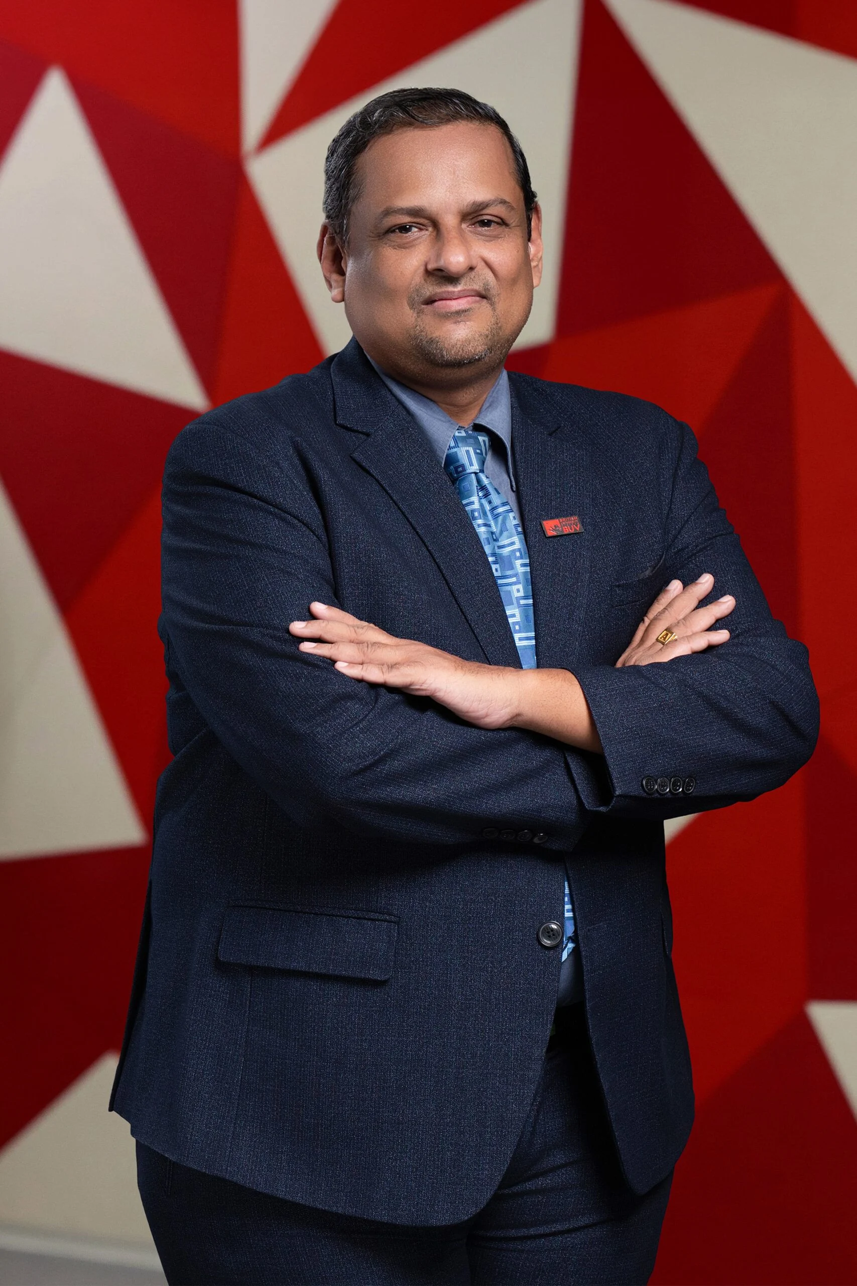 Ajay Pillai in a navy suit at British University Vietnam (BUV)