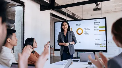 Finance professional presenting financial data and charts to colleagues during a business meeting