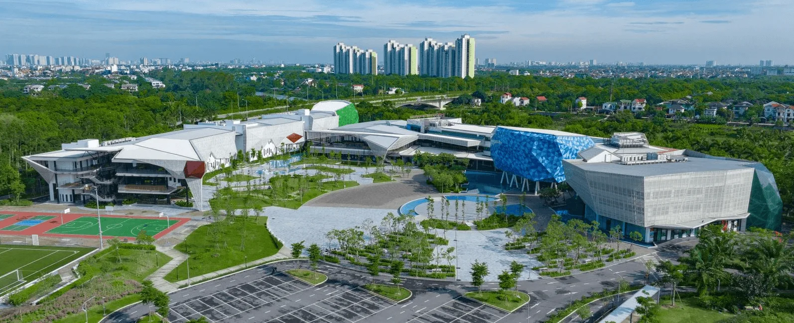 Aerial view of BUV campus in Ecopark, Vietnam, featuring modern buildings, sports courts, and green spaces