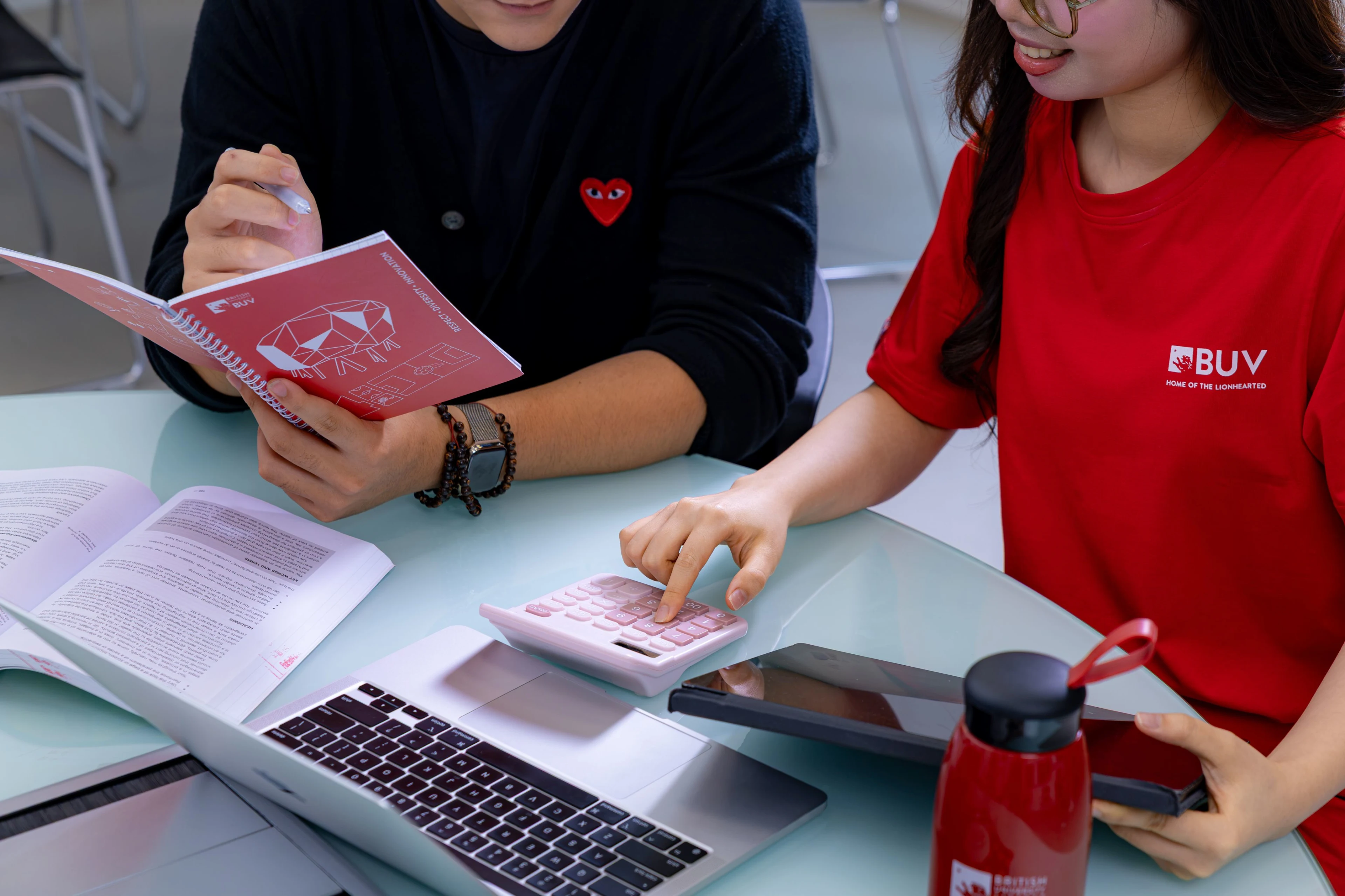 Sinh viên BUV học nhóm với máy tính, laptop và tài liệu tại Đại học Anh Quốc Việt Nam.