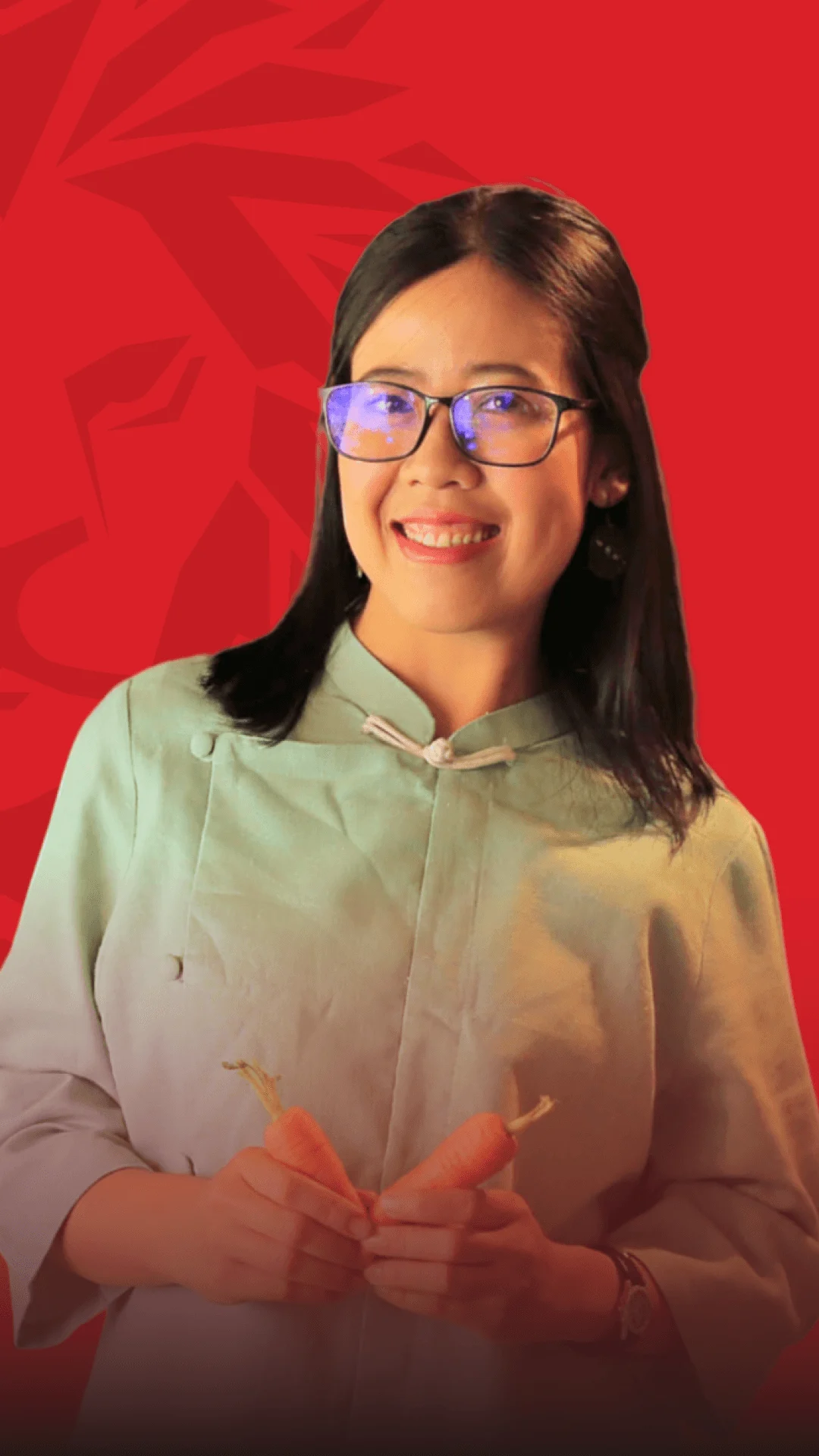A portrait of a smiling BUV alumna in a light green blouse, standing against a red background, with hands forming a heart shape.
