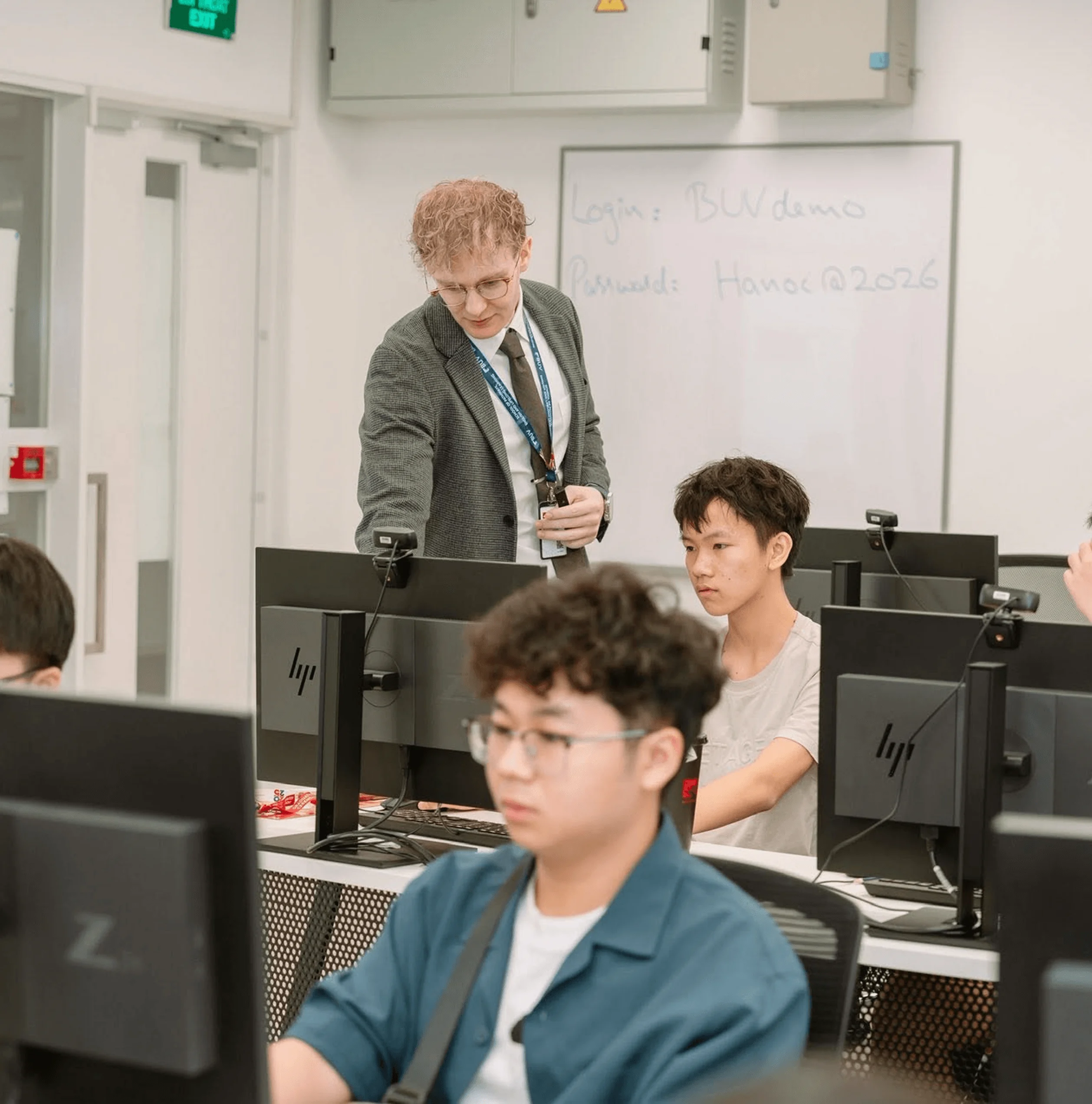 BUV lecturer teaching students in a computer lab at British University Vietnam (BUV)