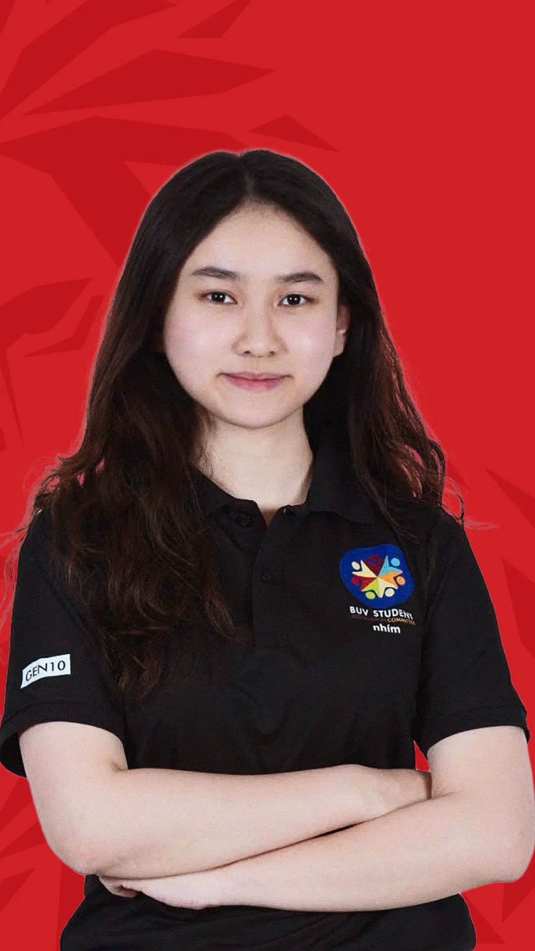 BUV alumna Linh Giang in a black student polo, arms crossed against a red background.