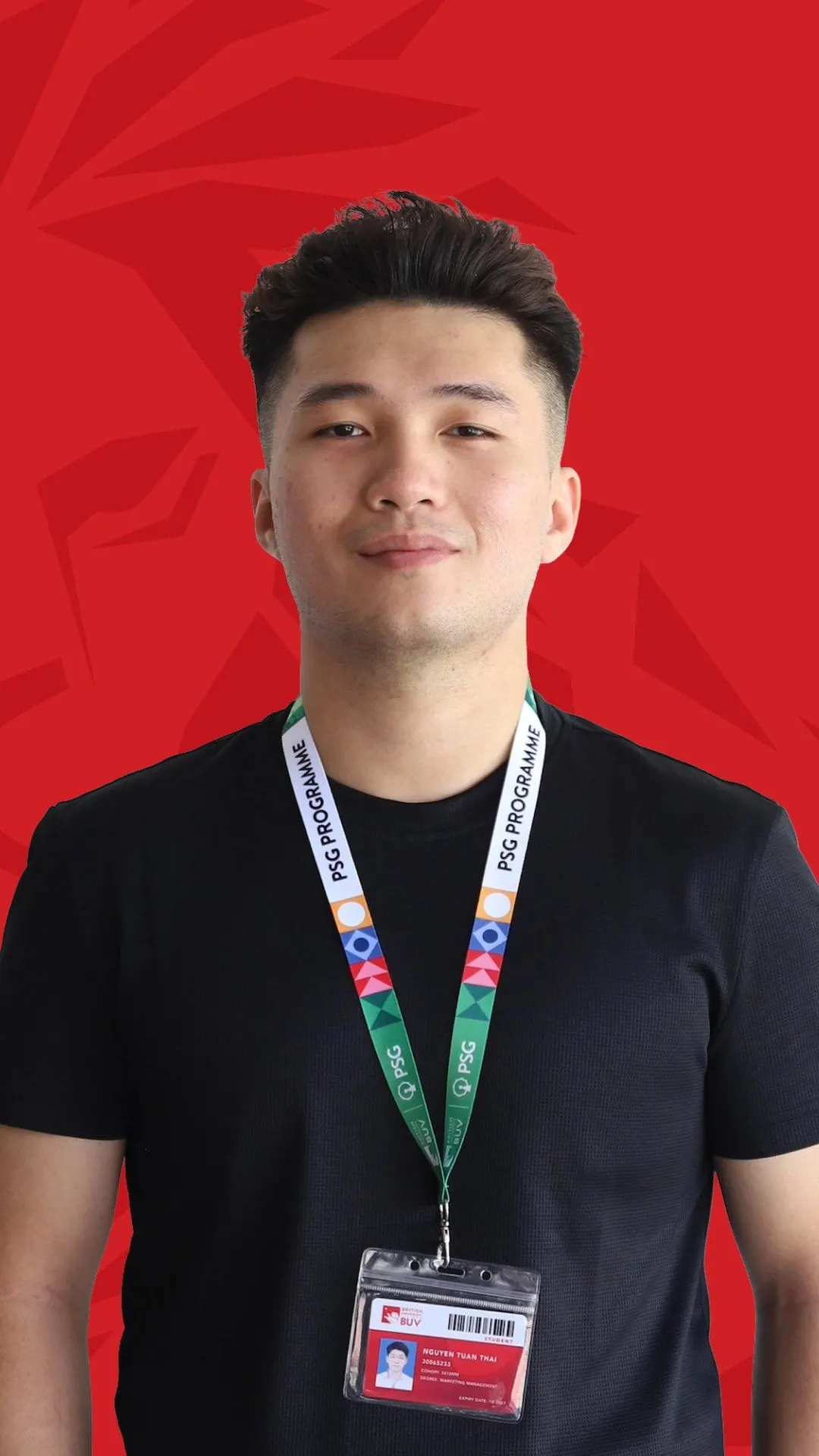 BUV alumnus Tan Thanh in a black shirt and PSG lanyard against a red background.