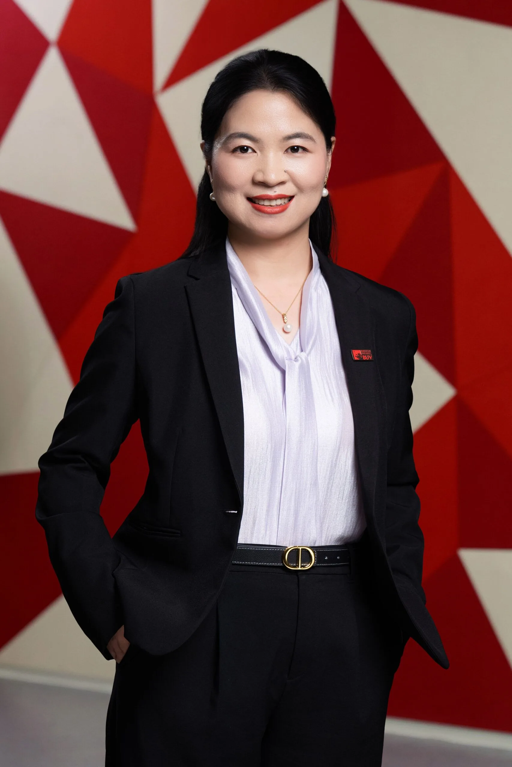A professional head-and-shoulders portrait of Tingting Xie smiling in a dark suit against a red-and-white geometric backdrop.