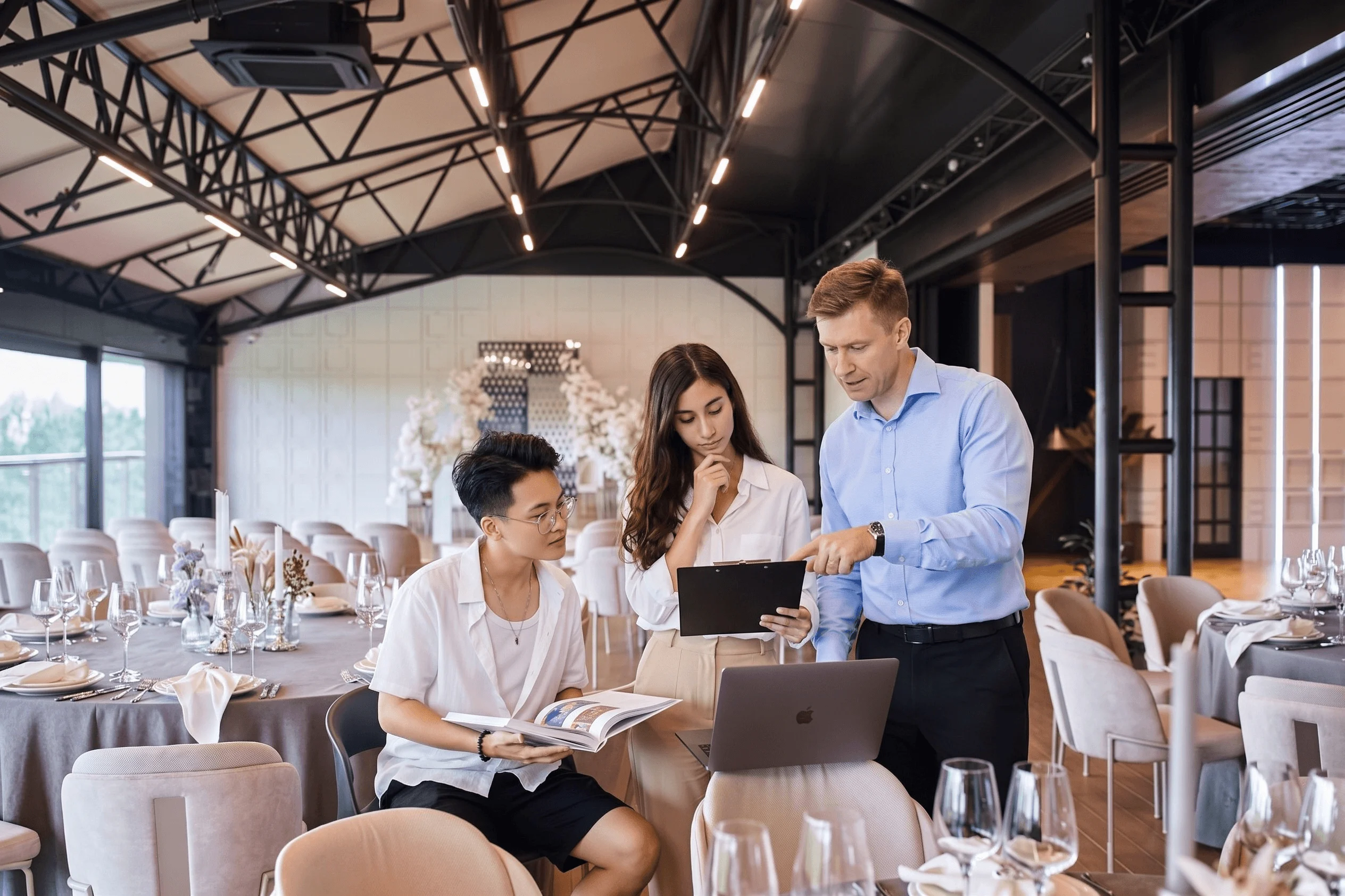 BUV hospitality management lecturer and students reviewing event plans in a training restaurant