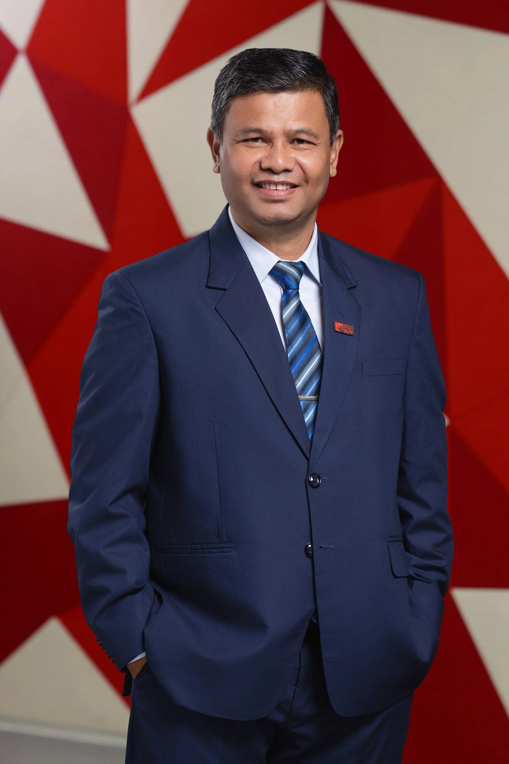 Shashi Chaudhary in a navy suit at British University Vietnam (BUV)
