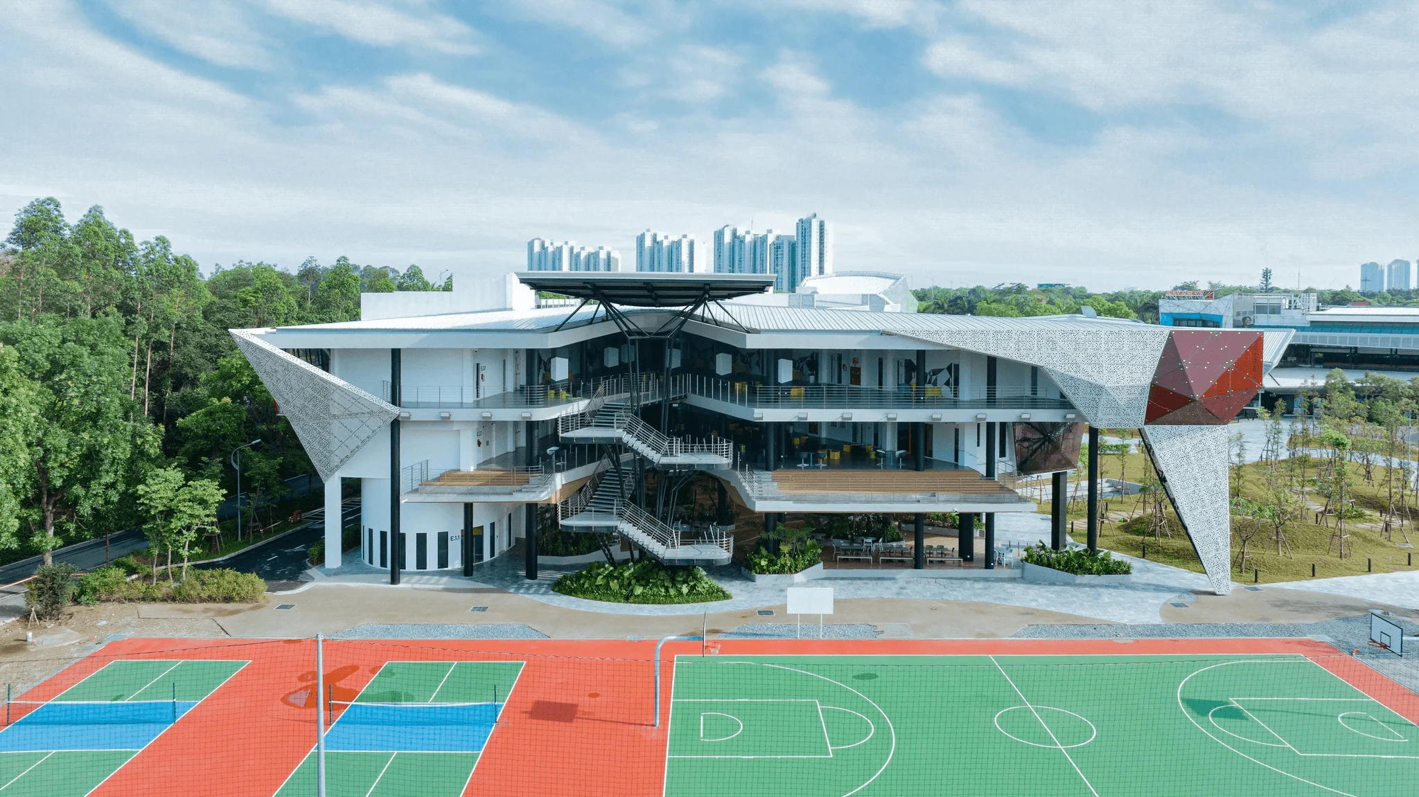 BUV campus with a modern university building and outdoor basketball courts in Vietnam