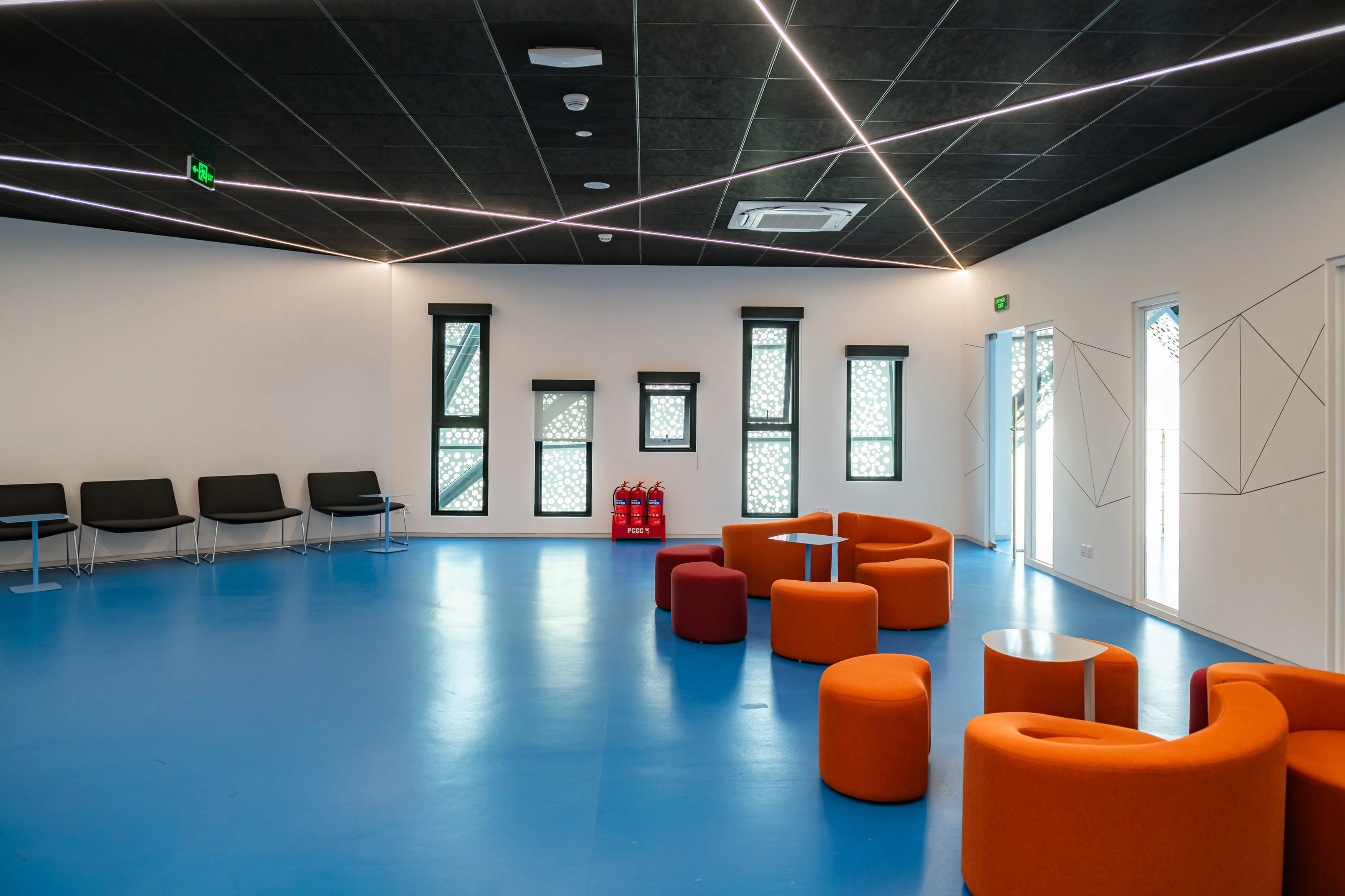 Modern student lounge at British University Vietnam (BUV) with colorful seating and blue flooring