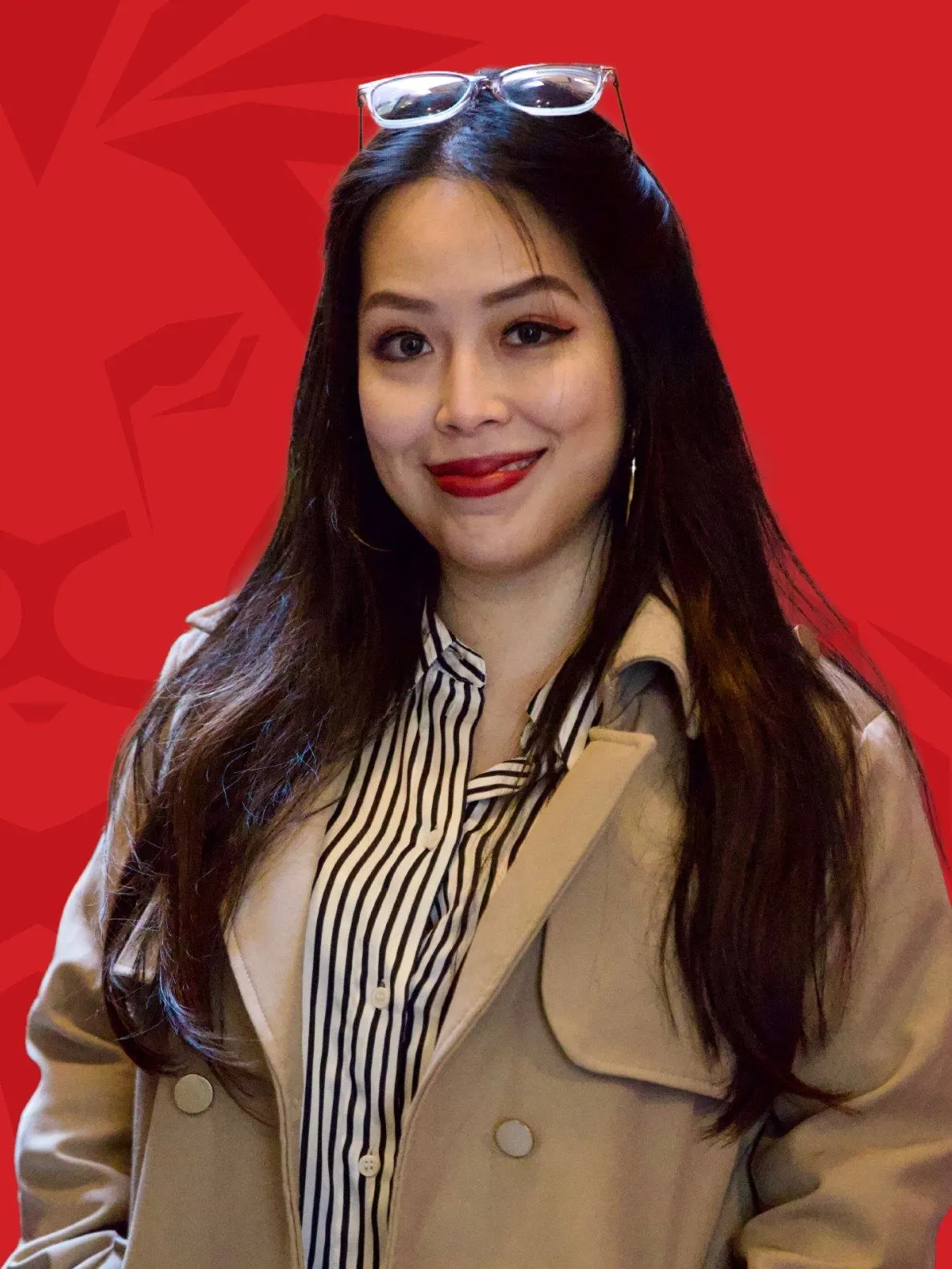 Portrait of Vietnamese singer Bích Phương in a beige coat against a red Lionhearted event backdrop.
