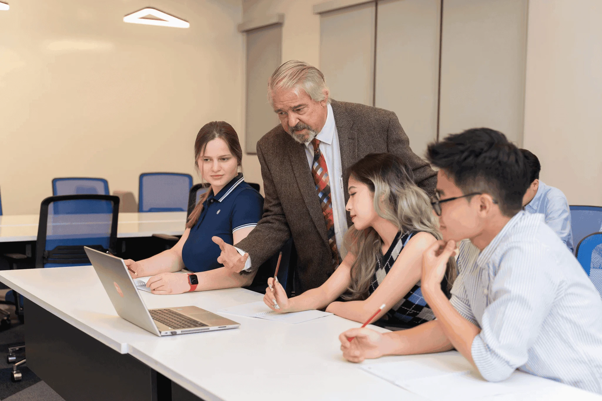 BUV students receive academic support from a lecturer during a collaborative classroom discussion.