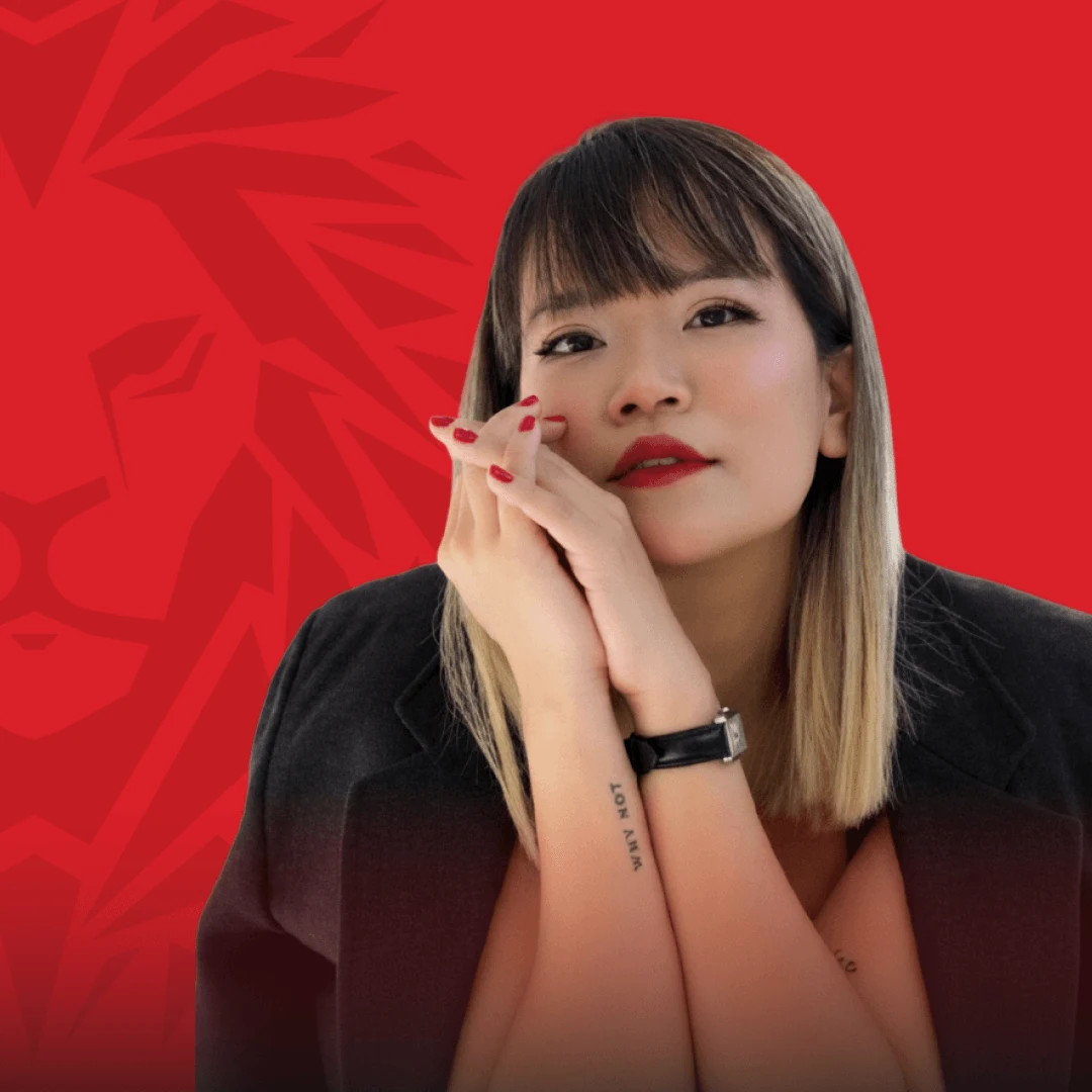 BUV alumna portrait in black blazer against a red graphic background