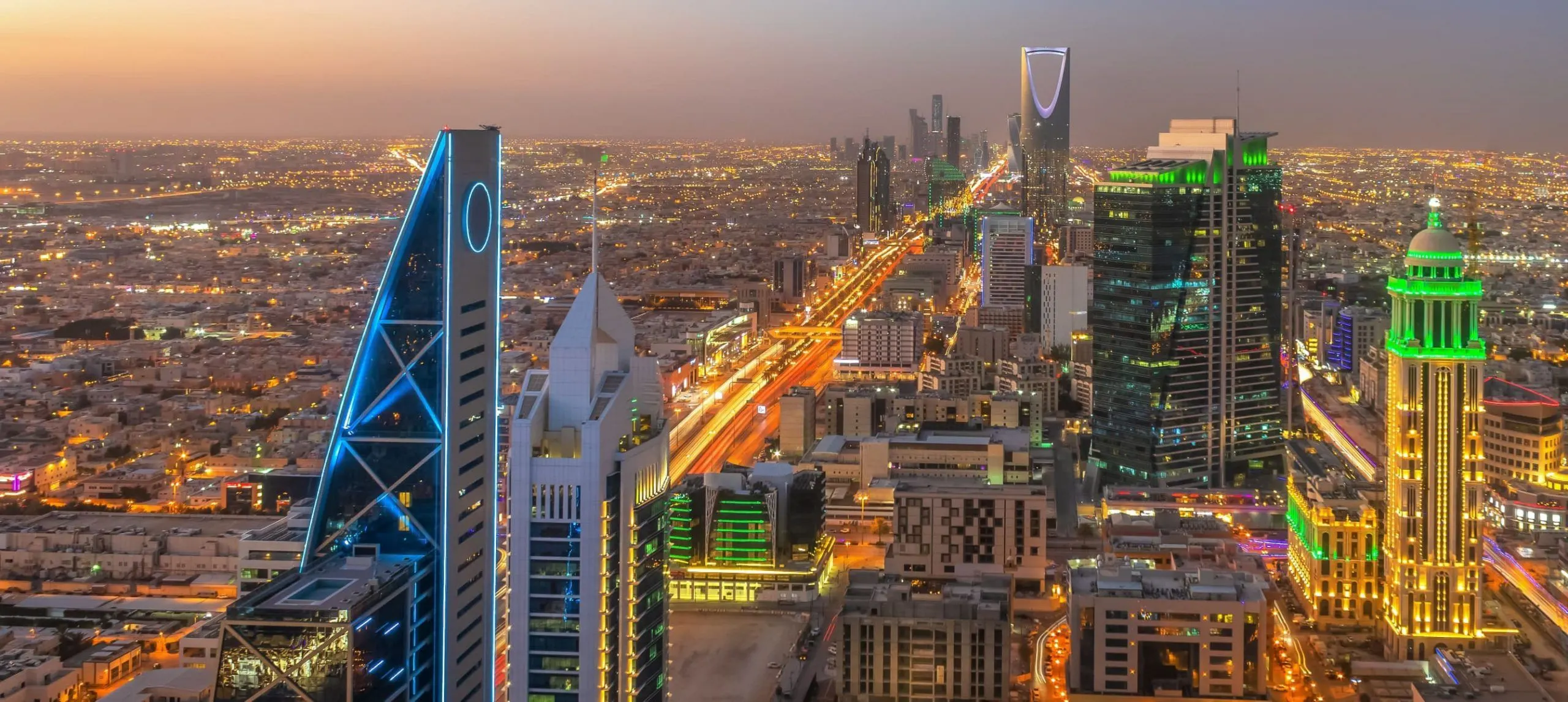 Riyadh skyline at dusk with illuminated skyscrapers and city lights, Saudi Arabia